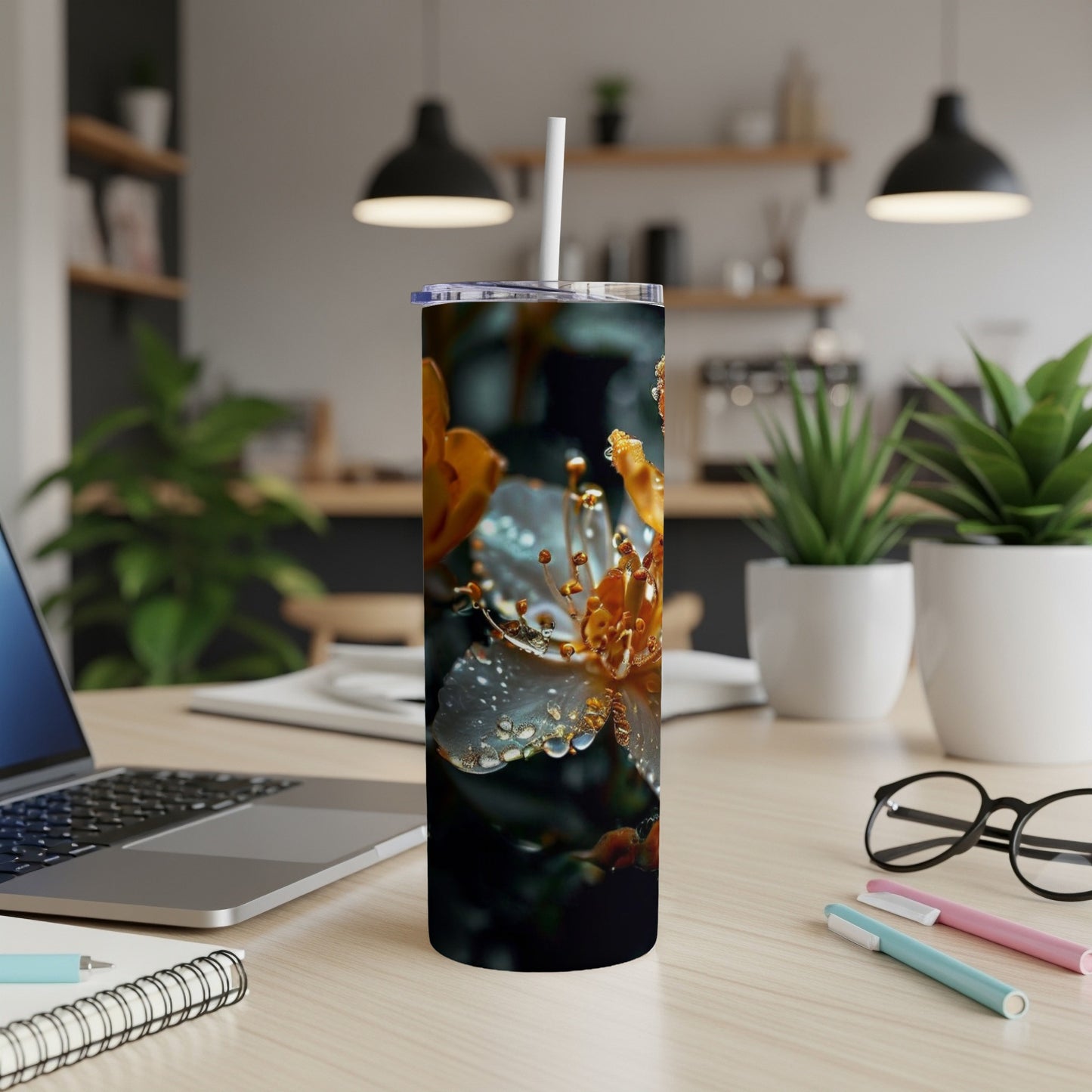 White tumbler with close-up floral design, resting on a desk.