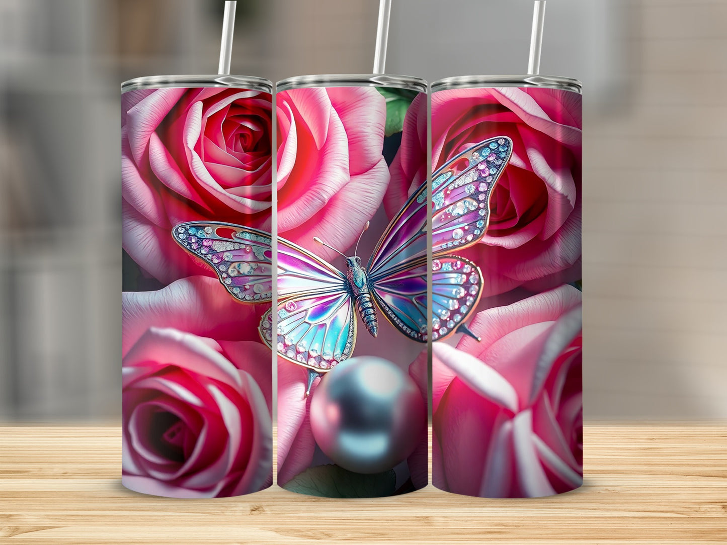 Three tumblers with pink roses and bejeweled butterflies against wooden background.