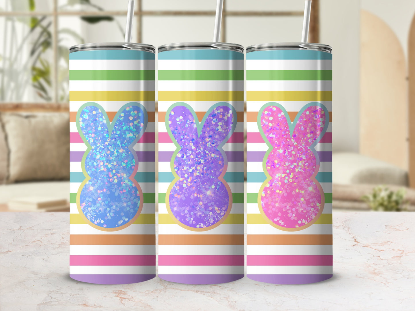 Three pastel striped tumblers with glitter bunny designs.