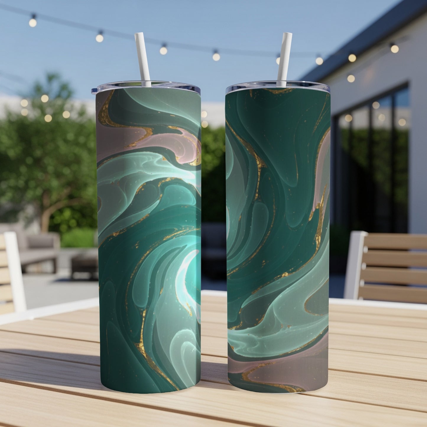 Two tumblers with abstract green and gold marble design on a table.