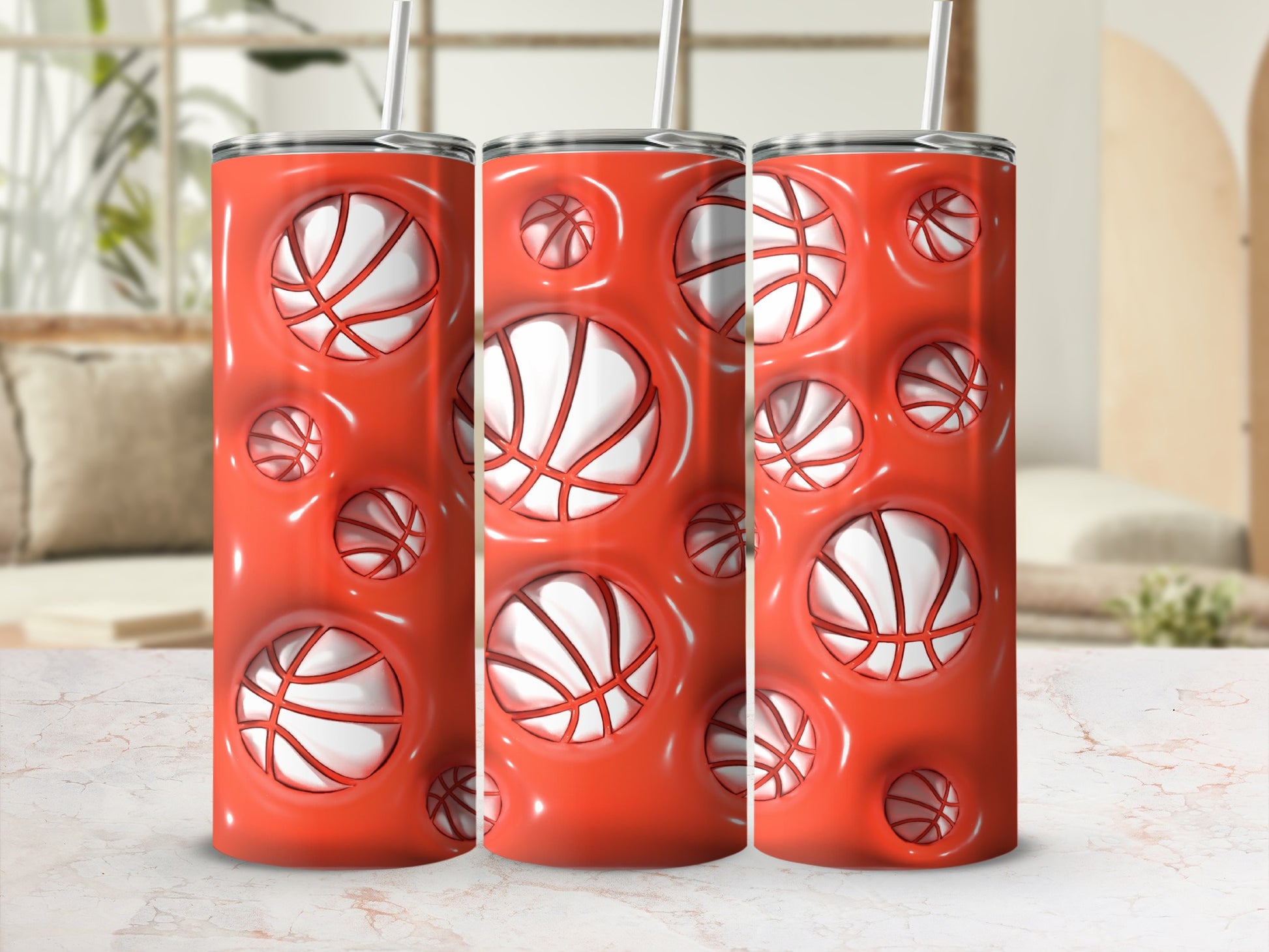 Three red tumblers with basketball design and white straws.