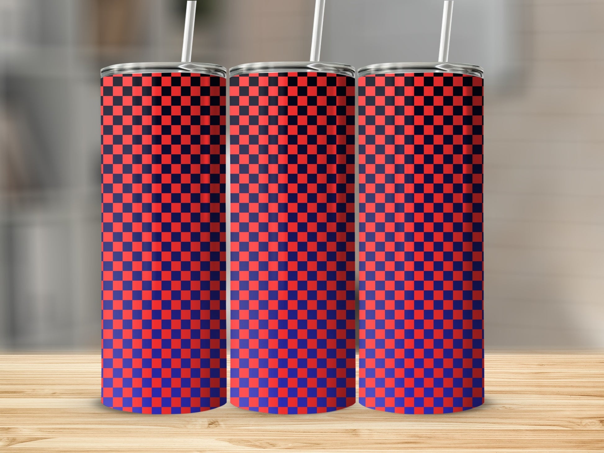 Three tall tumblers with a red and blue checkered pattern on a wooden surface.