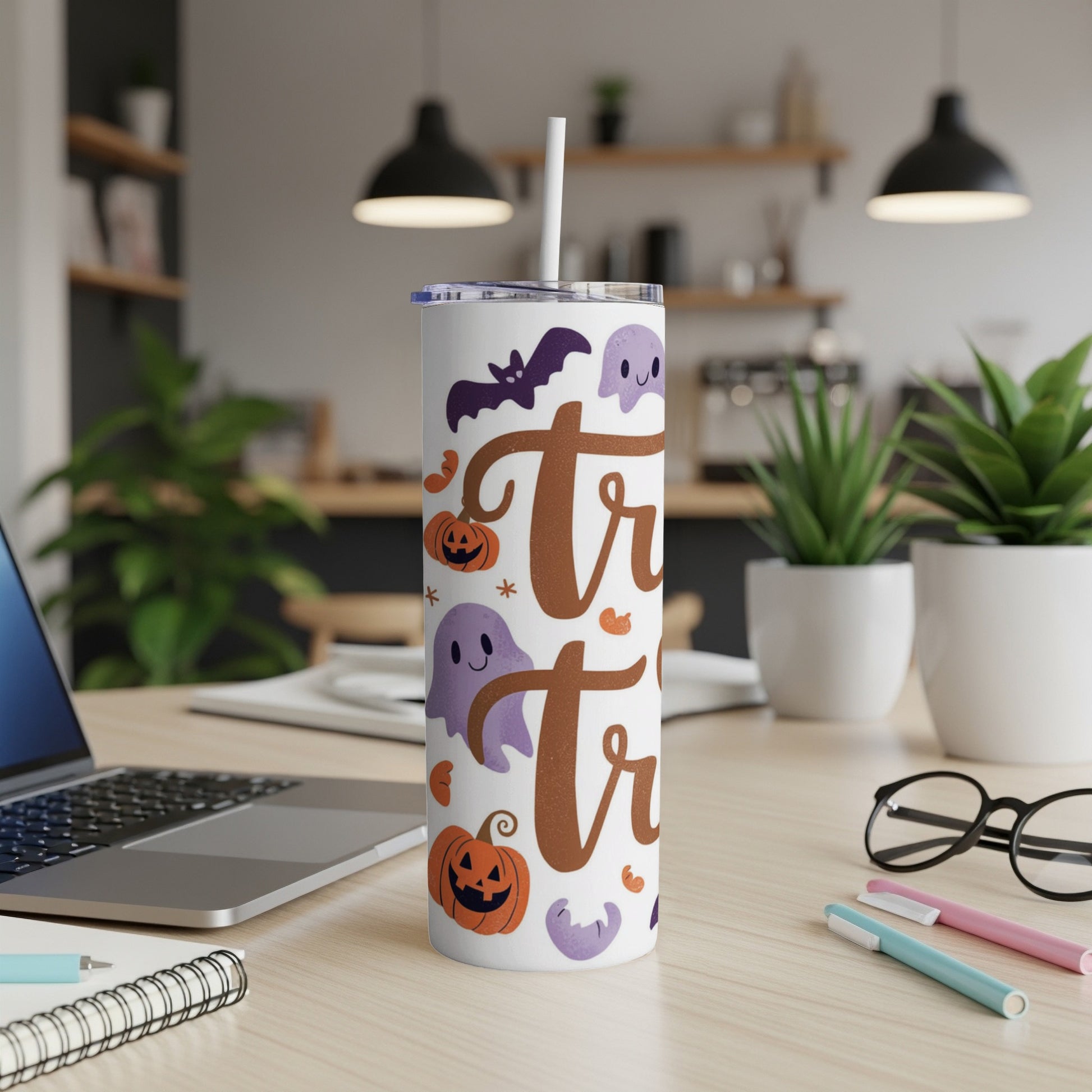 White tumbler with Halloween ghosts, bats, and pumpkins, saying "treat".