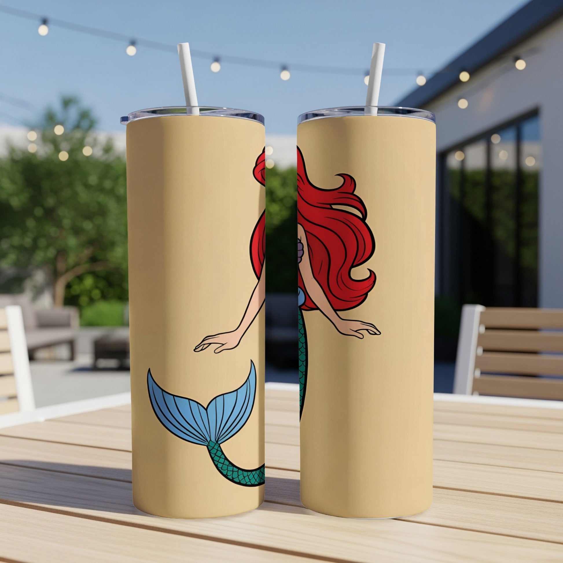 Two tall, tan tumblers featuring Ariel from The Little Mermaid with a turquoise tail.