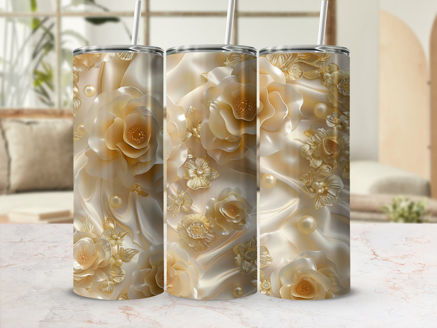 Triptych of tumblers with ornate gold floral and pearl designs on satin.