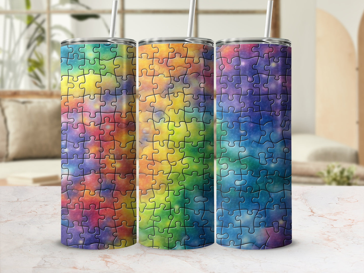 Three tumblers with colorful puzzle piece designs in rainbow gradients.