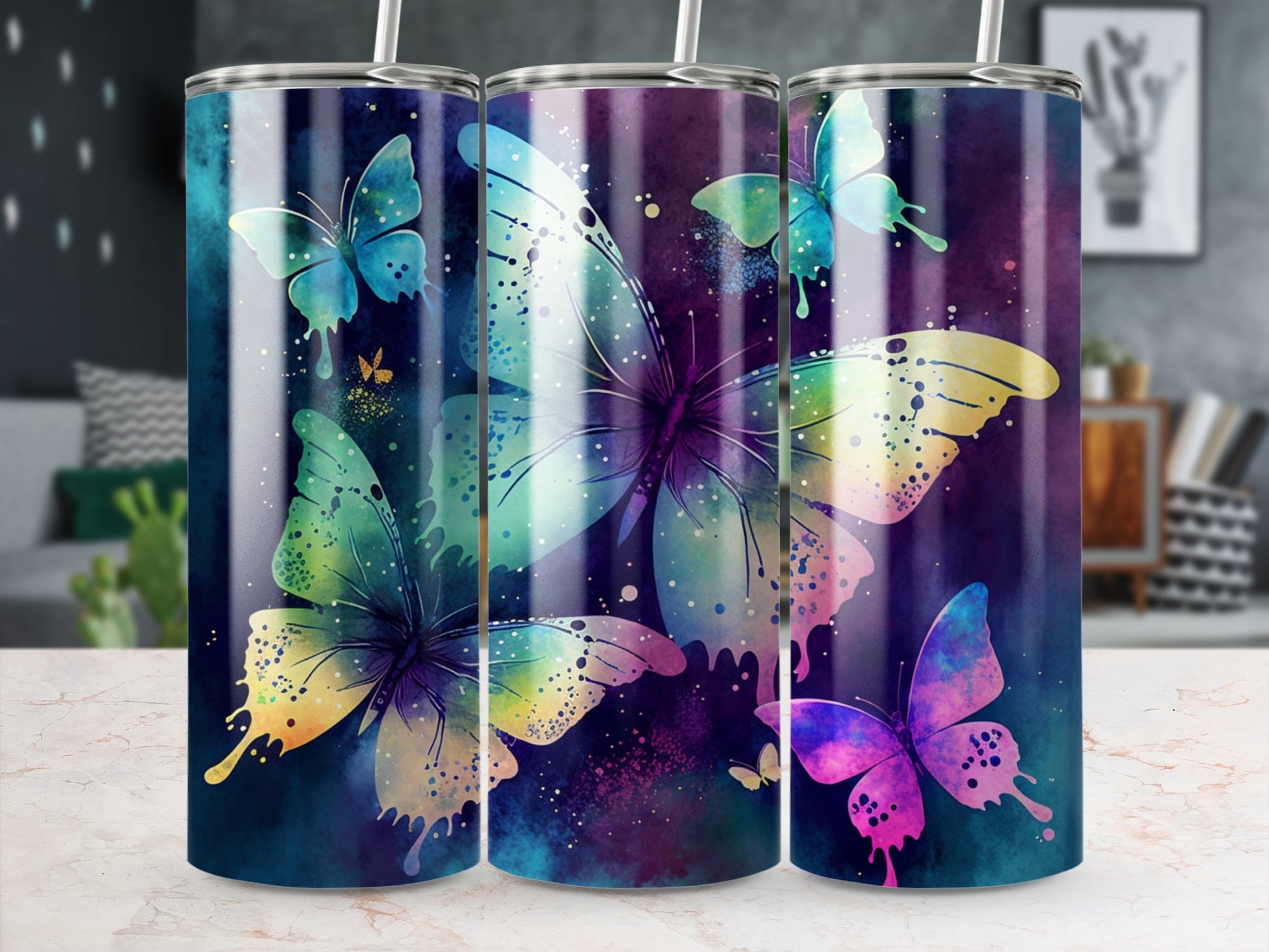 Three tumblers with watercolor butterfly designs and a starry background.