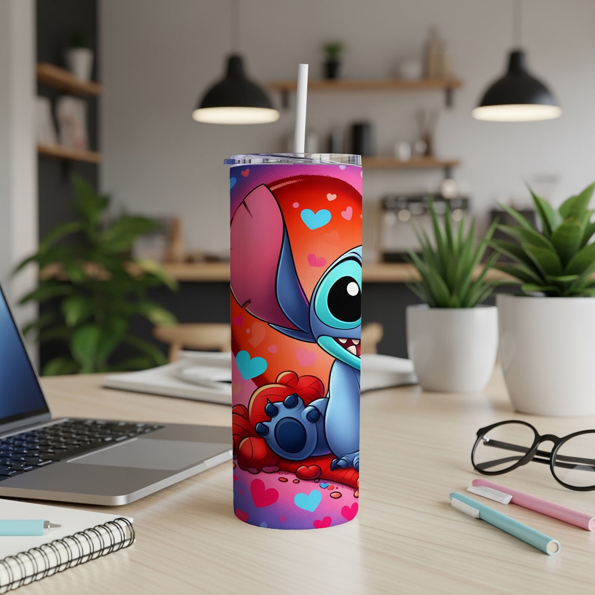 Blue Stitch character on a colorful tumbler with hearts and a straw.