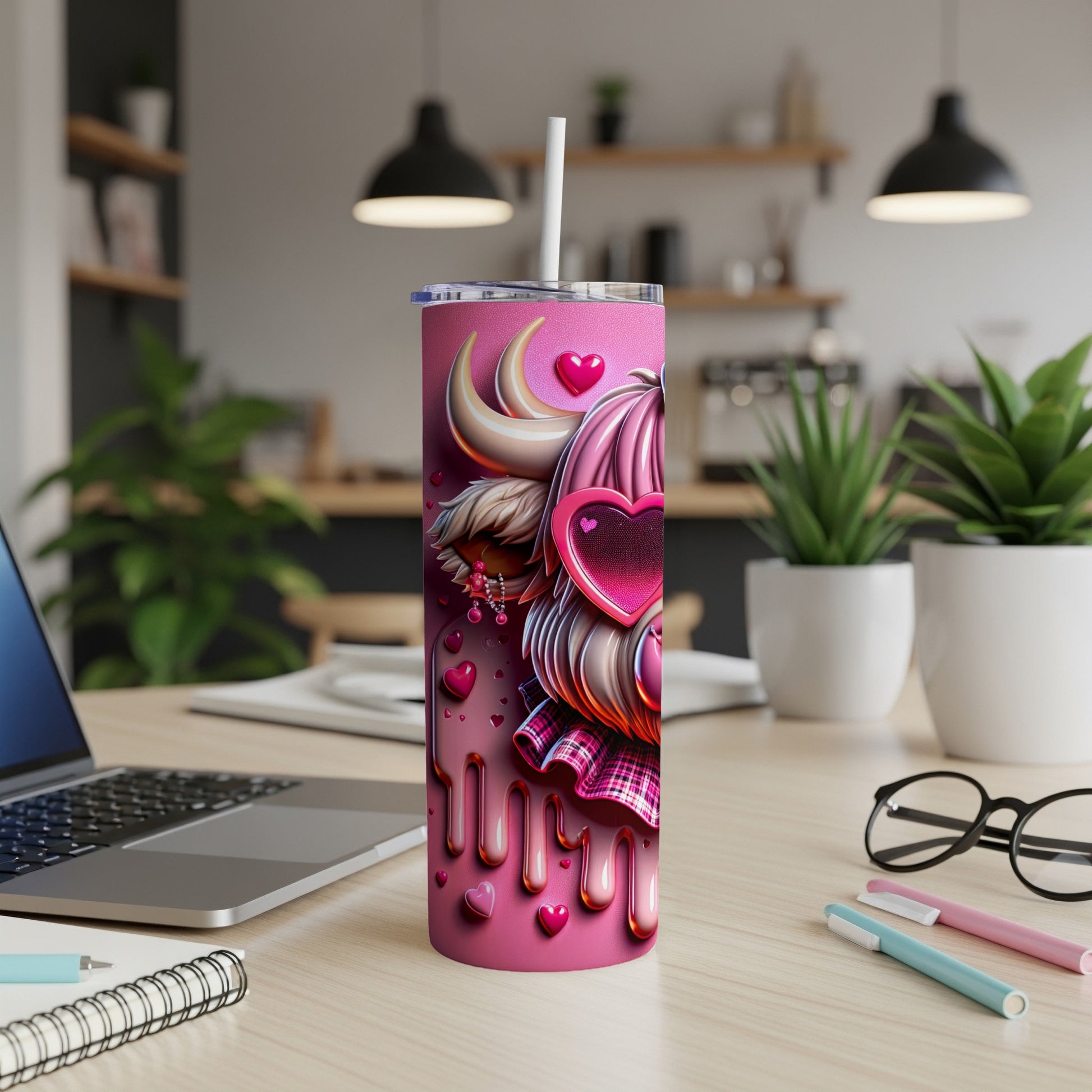 Pink tumbler with hearts, fluffy ears, and plaid pattern, on a desk.