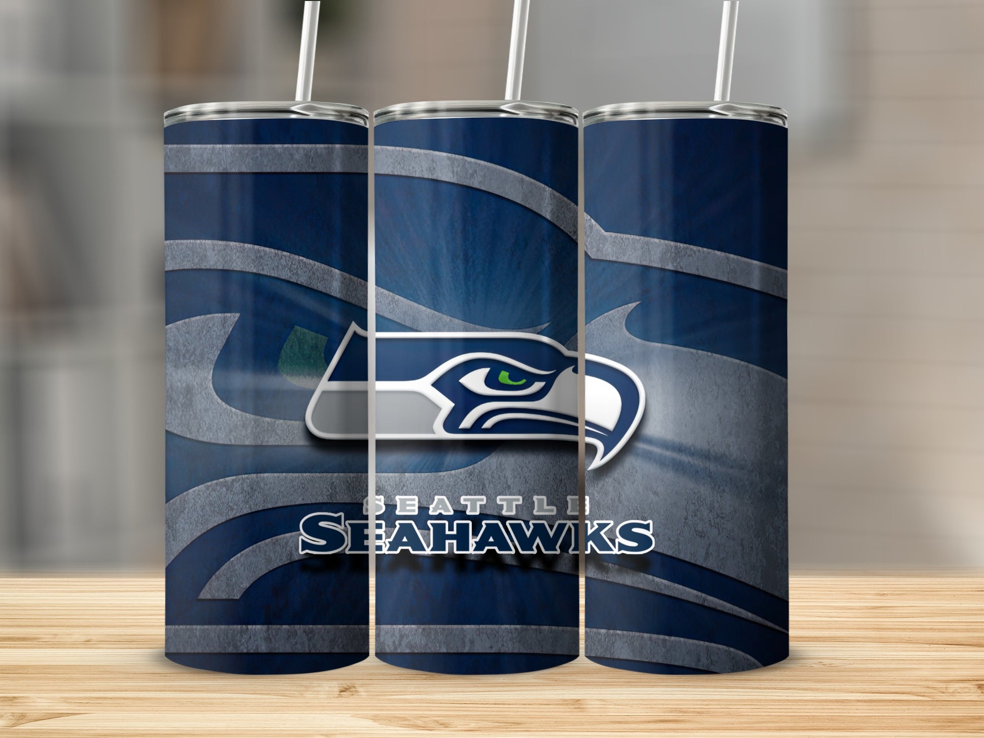 Seattle Seahawks logo and text on three navy blue tumblers with straws.