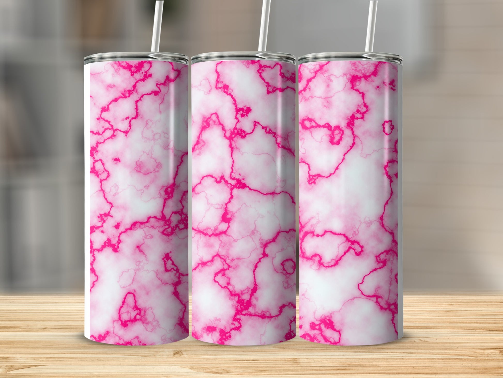 Three white tumblers with pink marble pattern and straws.
