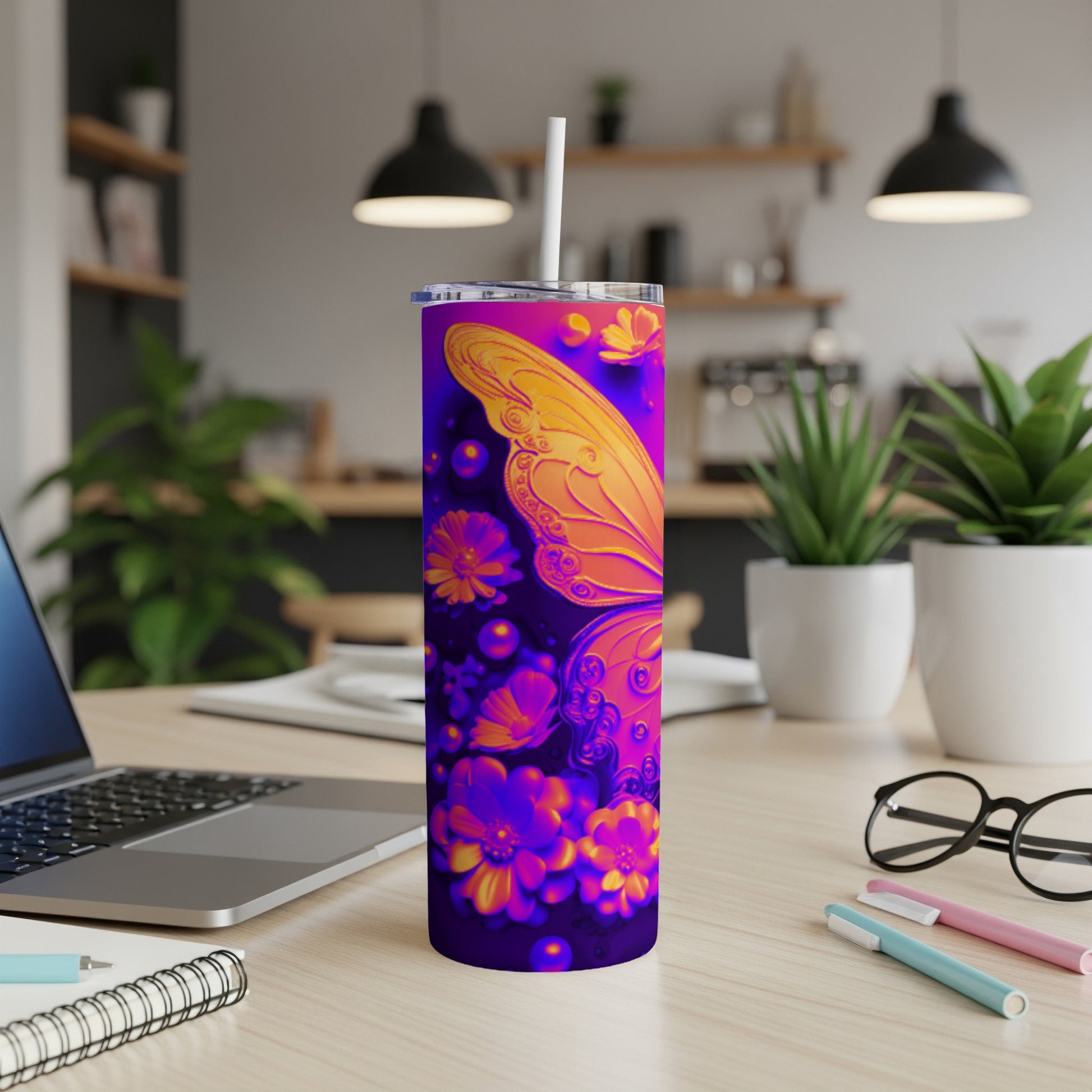 Purple tumbler with orange butterfly and floral design, straw inserted.
