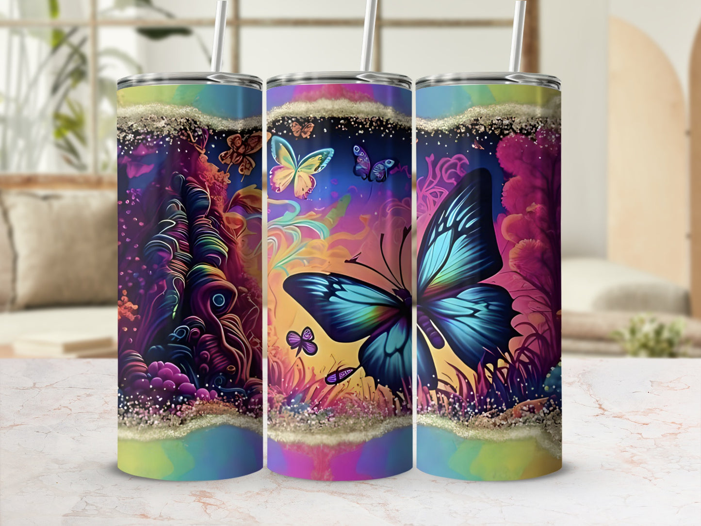 Three tumblers with colorful butterfly and abstract floral designs.