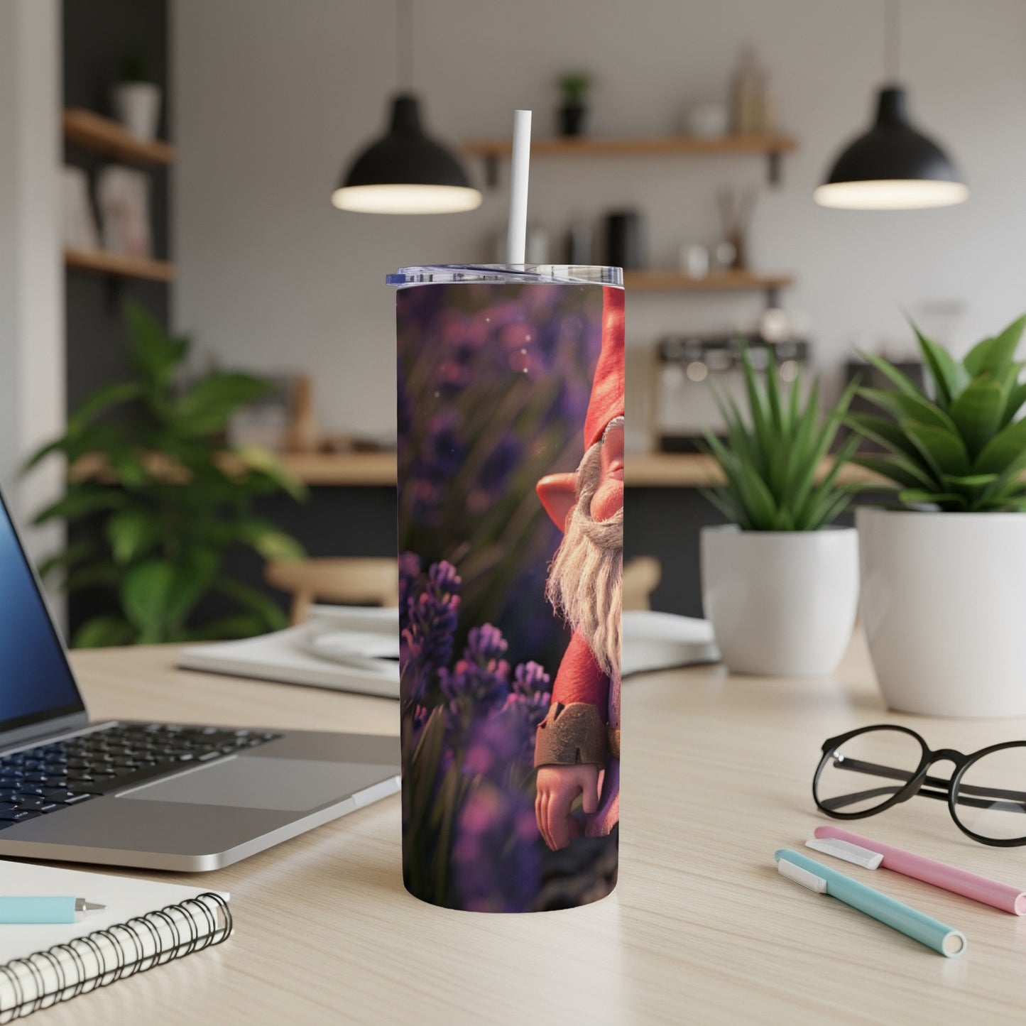 Tumbler with a gnome illustration and lavender background on a desk.
