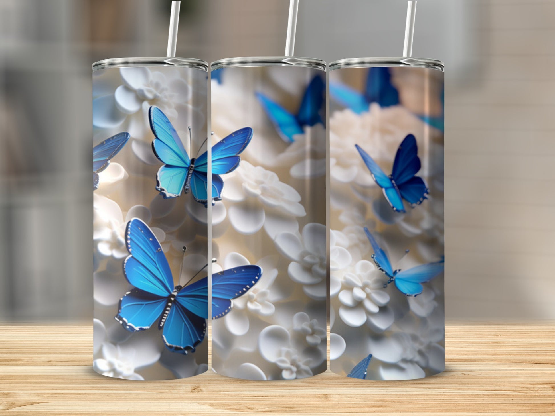 Three tumblers with blue butterflies and white flowers.