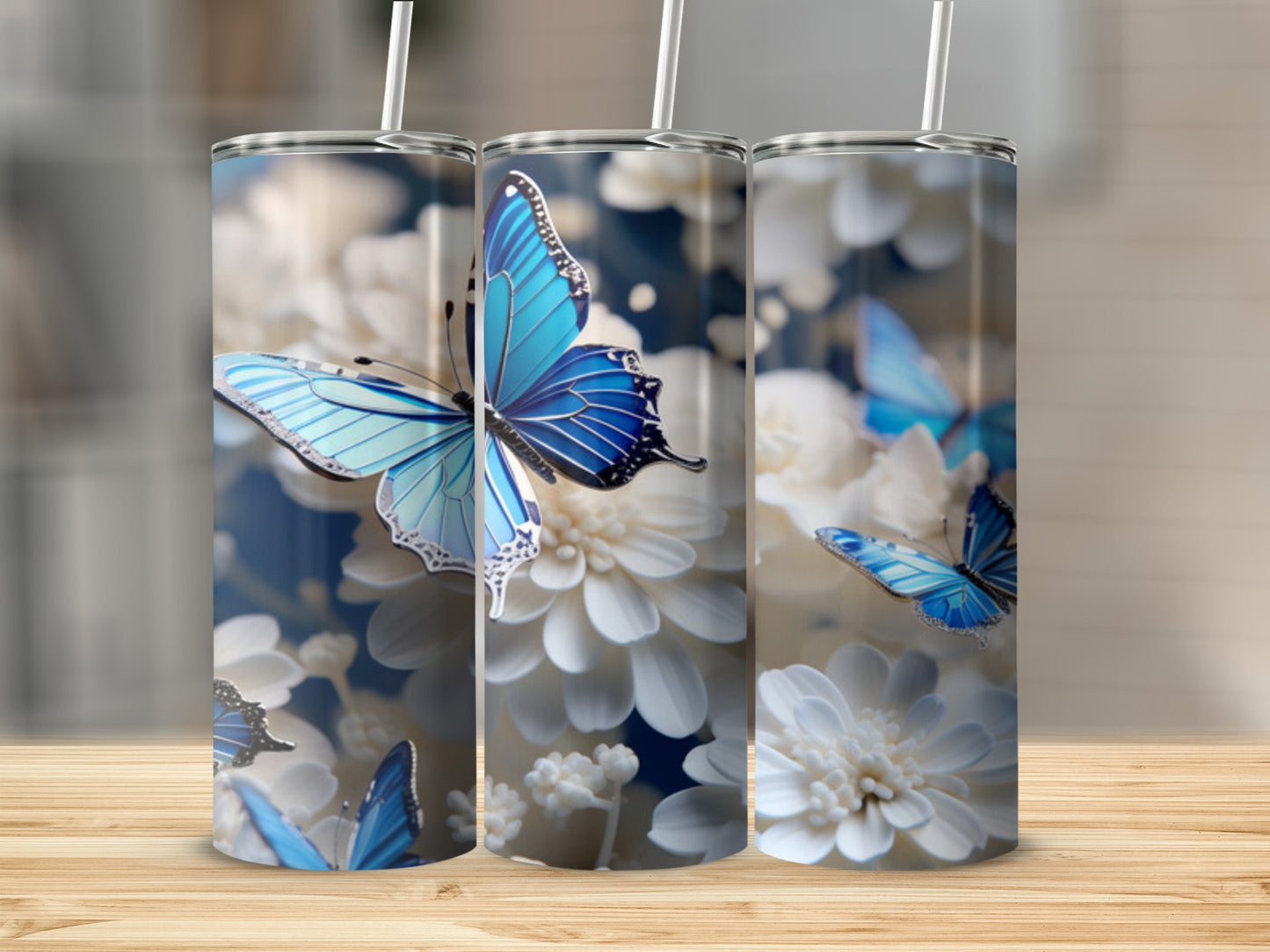 Blue butterflies on white flowers design on three tumblers.