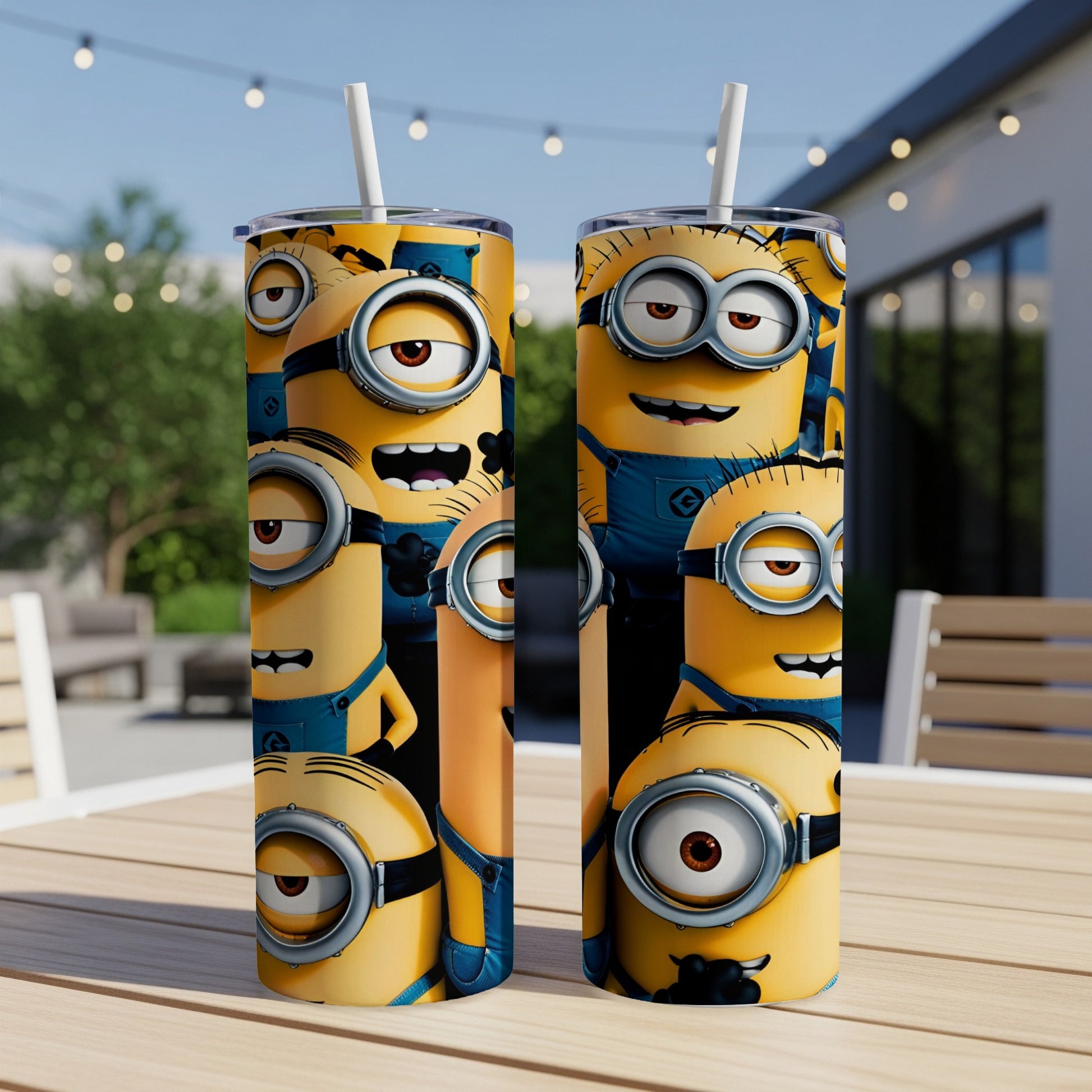 Two Minion-themed tumblers with straw on a table outdoors.