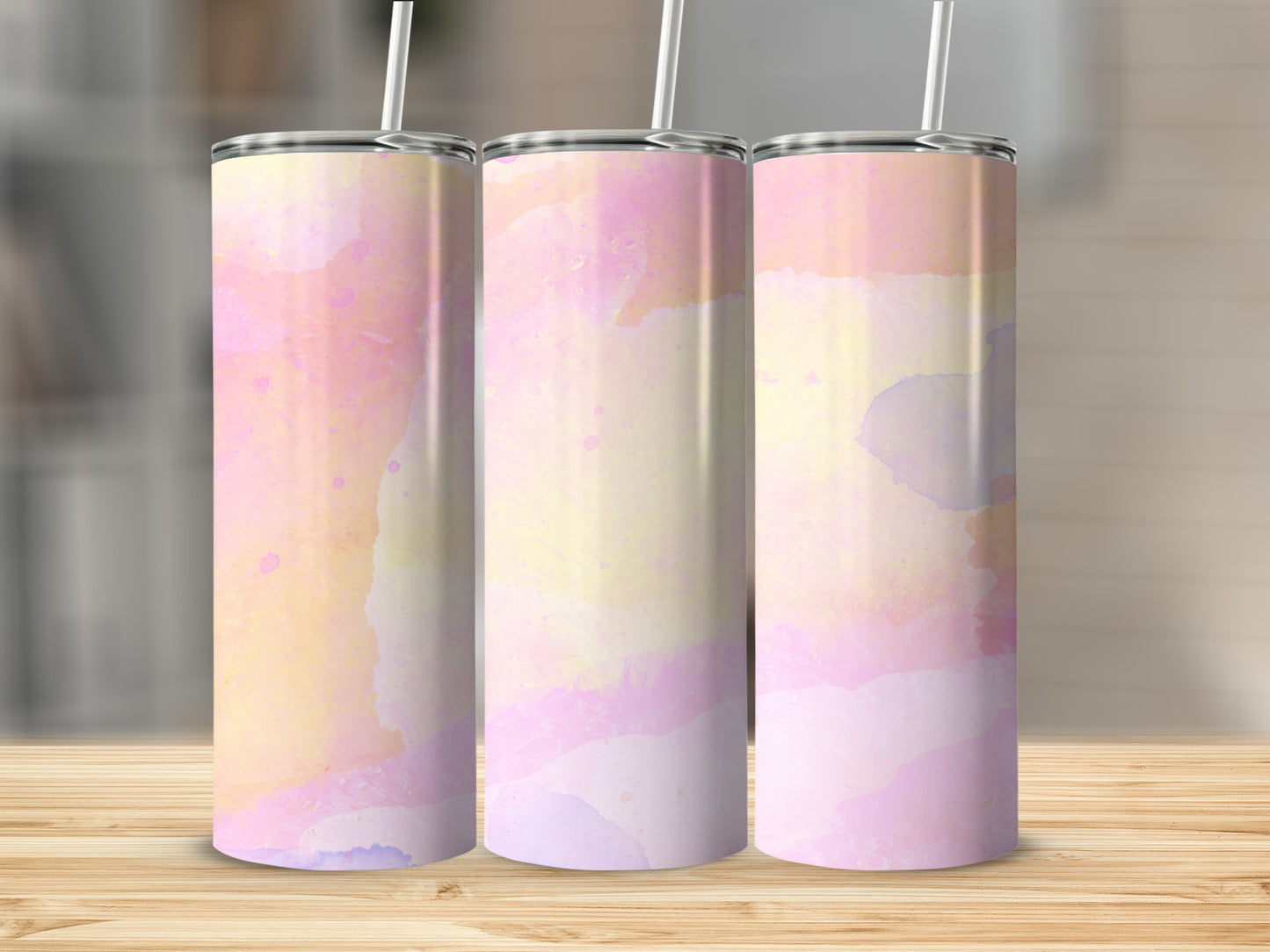 Three tumblers with pastel watercolor patterns in pink, yellow, and purple.