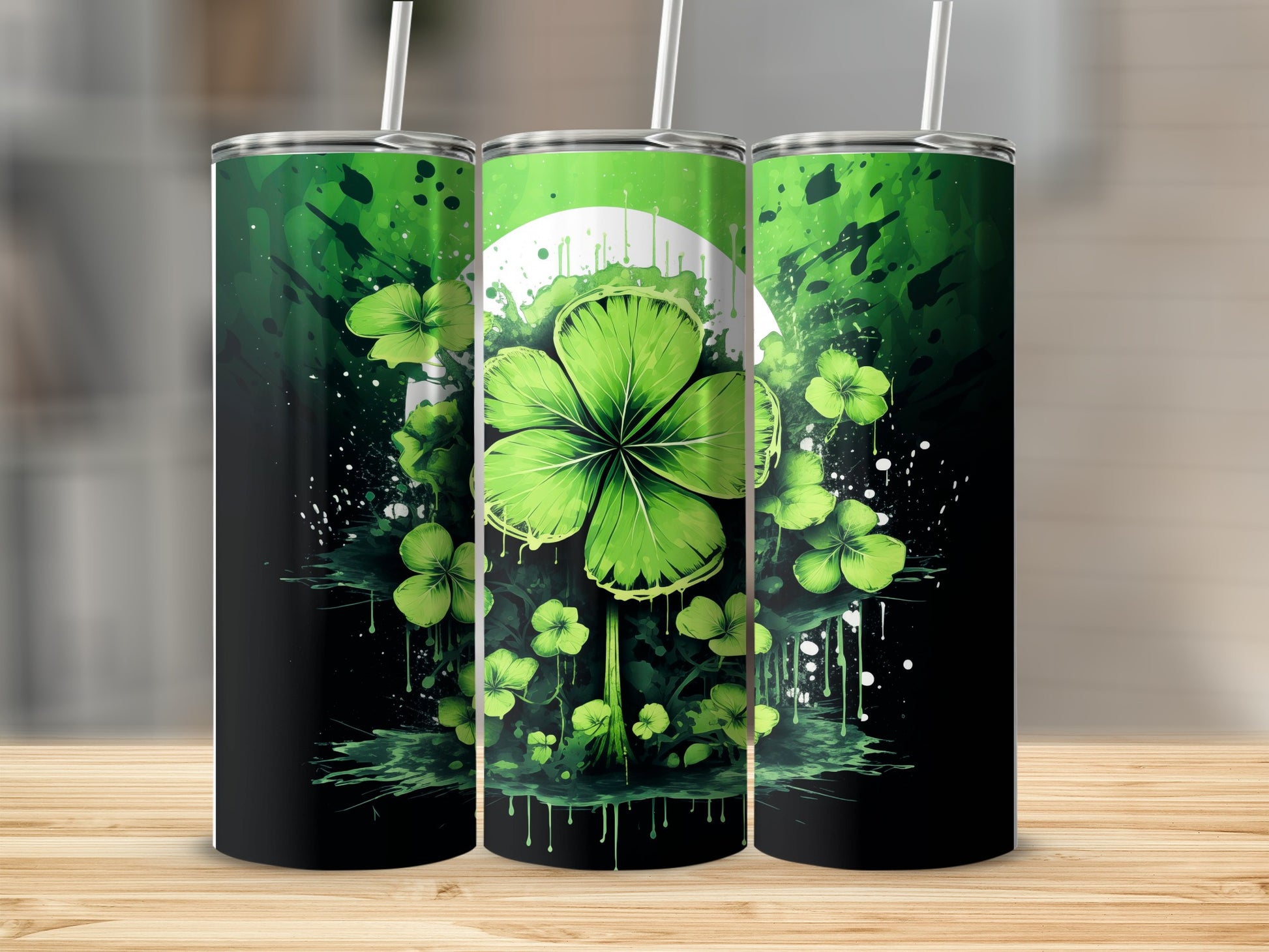 Three green tumblers with shamrocks and a circular white design.