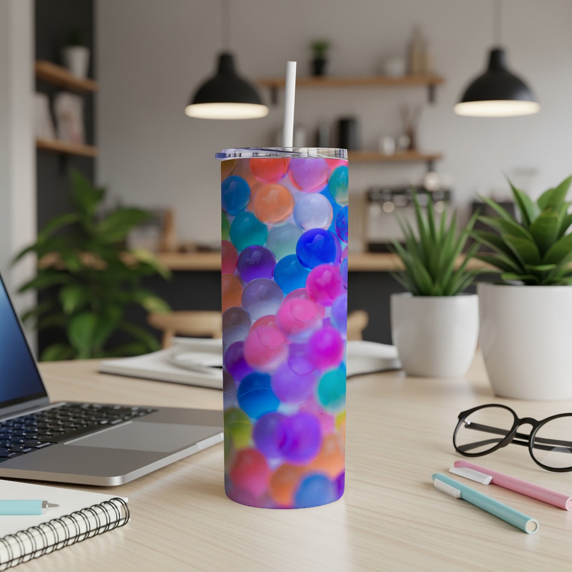 Tumbler with colorful, translucent spheres and a white straw.