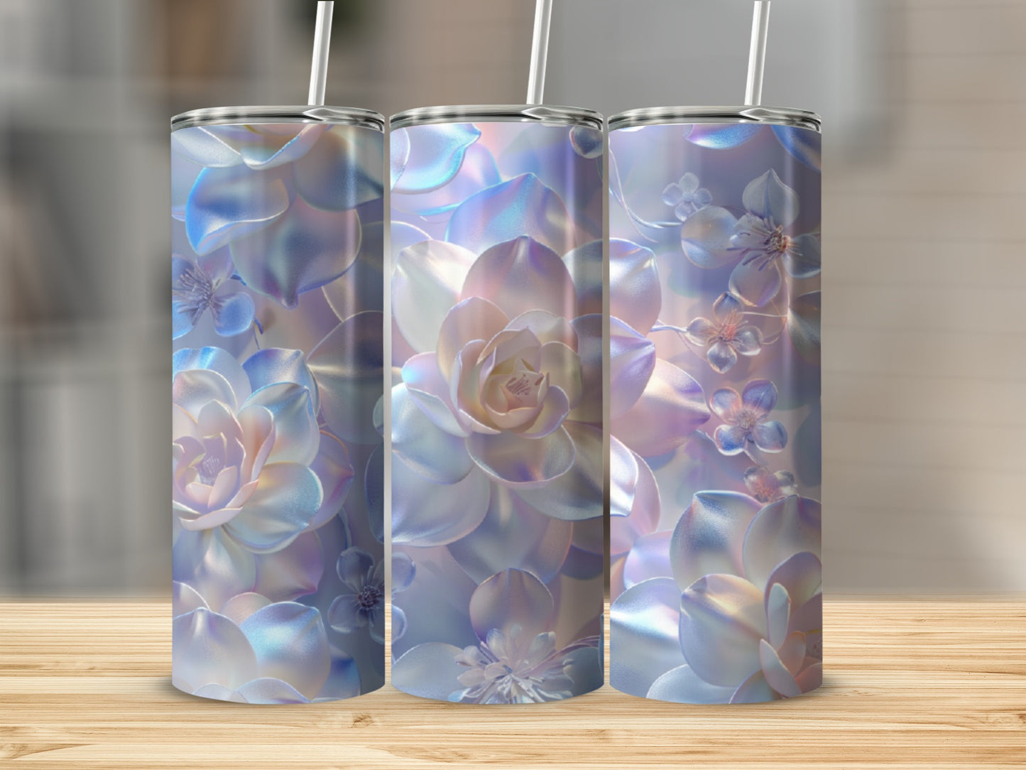 Three iridescent tumblers with floral succulent designs on a wooden surface.