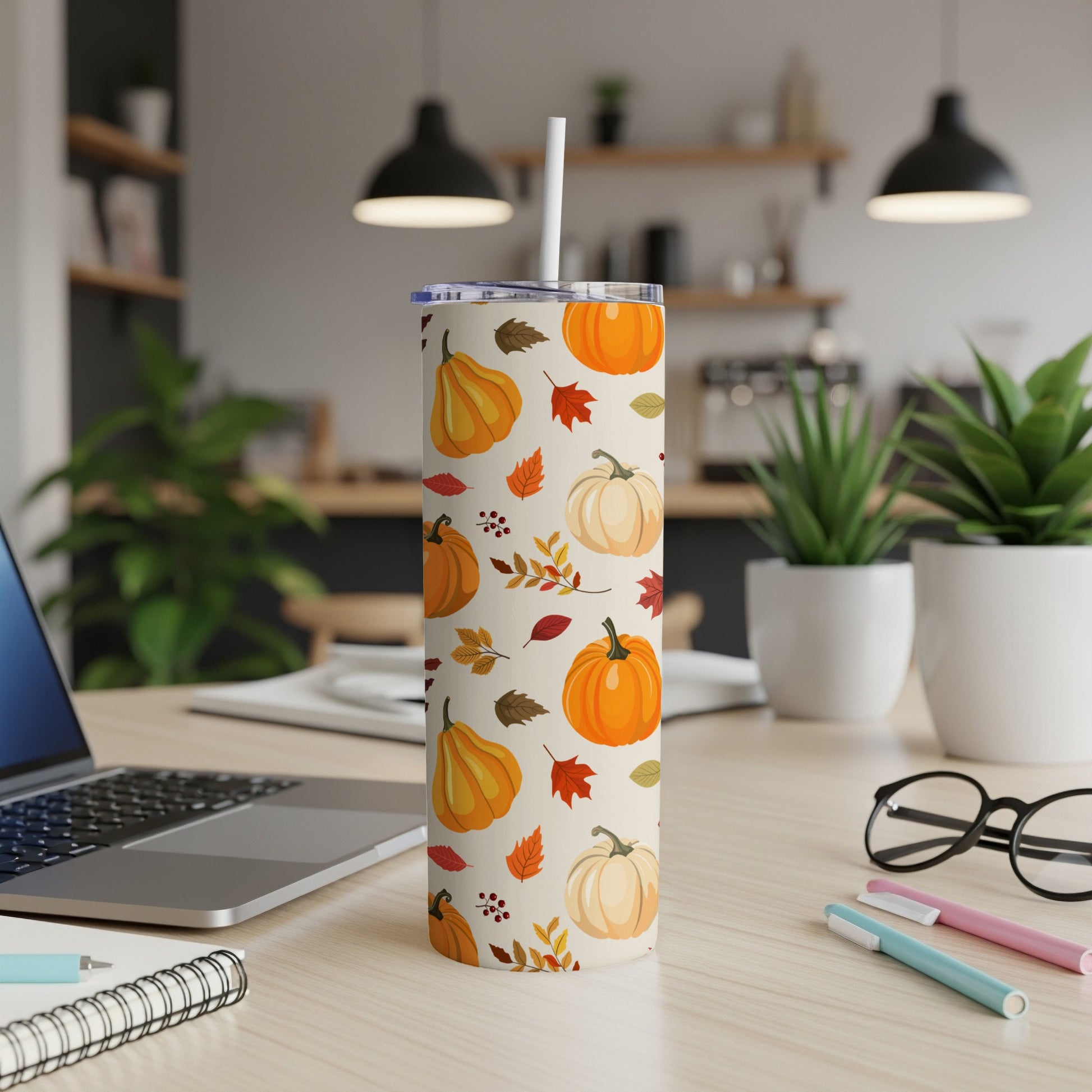Tumbler with a pumpkin and fall leaf pattern.
