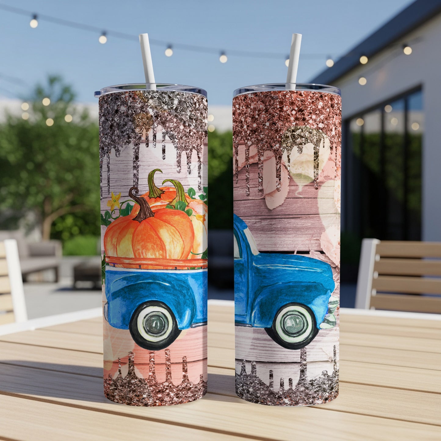 Blue truck with pumpkins and glitter accents on a rustic wood background.