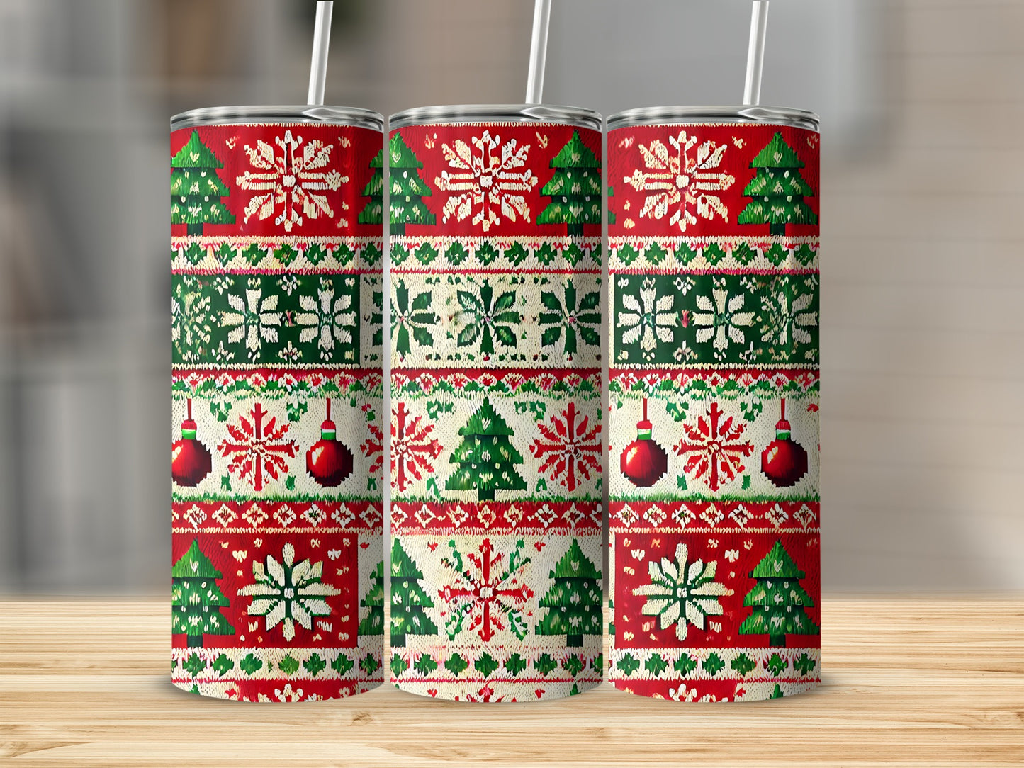 Three tumblers with a red, green, and white snowflake and Christmas tree pattern.