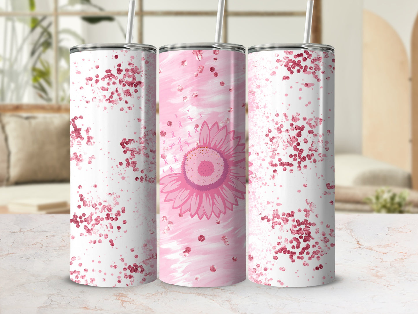Pink glitter and sunflower design on three tumblers with straws.