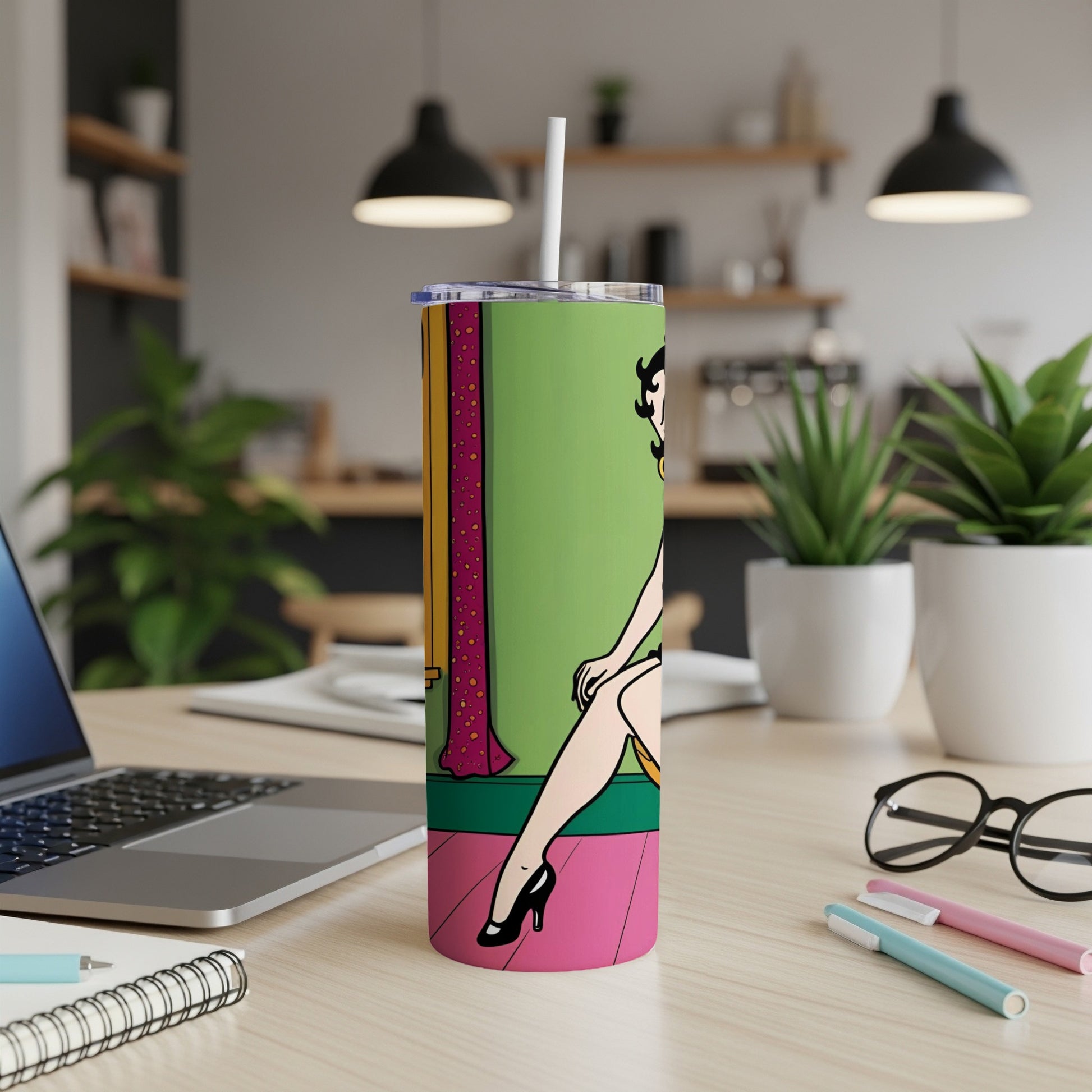 Betty Boop illustration on a green and pink tall tumbler with a straw.