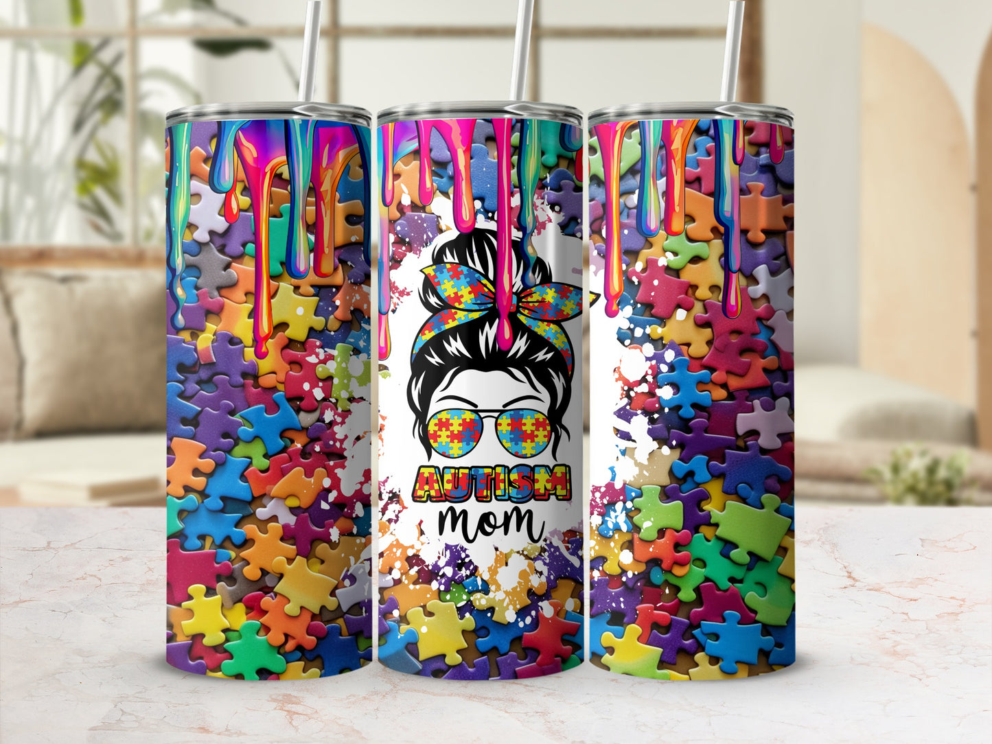 Colorful puzzle pattern tumbler with "autism mom" text and sunglasses.