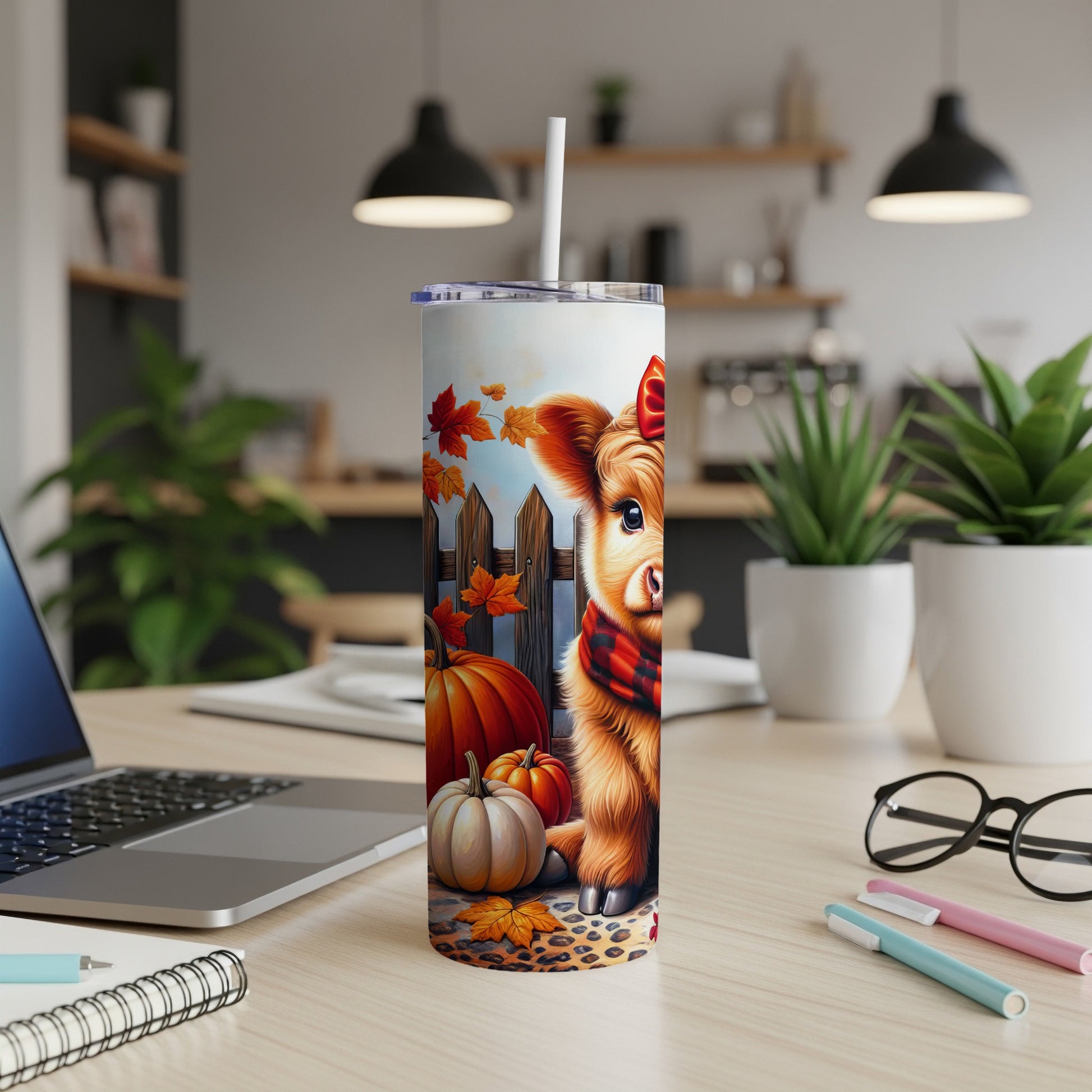 Cute cartoon Highland cow with pumpkins and autumn leaves on a tumbler.