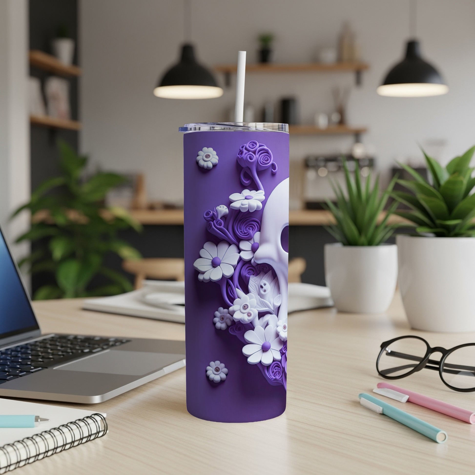 Purple tumbler with skull and floral embossed design, straw in lid.