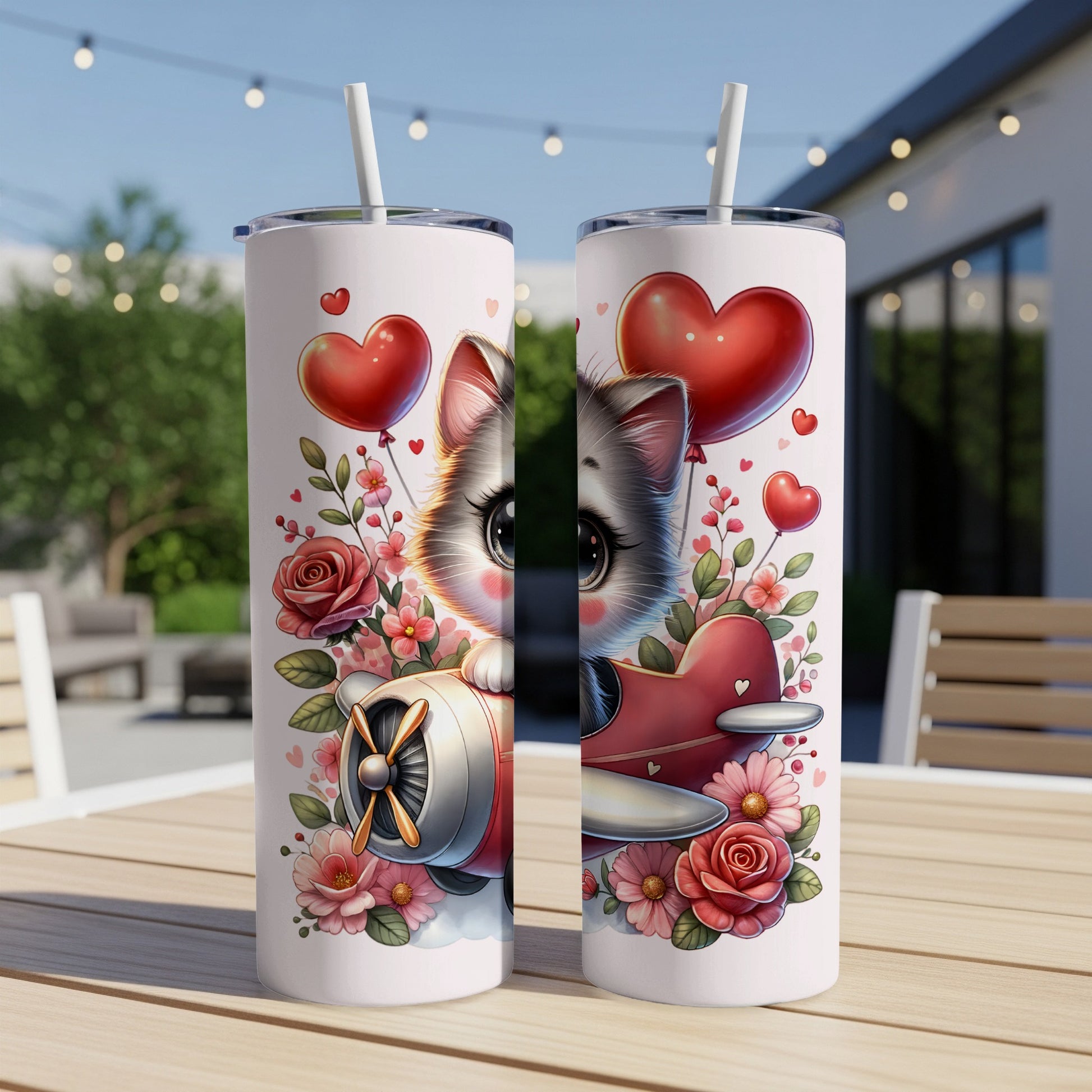 Cute kitten in airplane with roses and heart balloons on a tumbler.