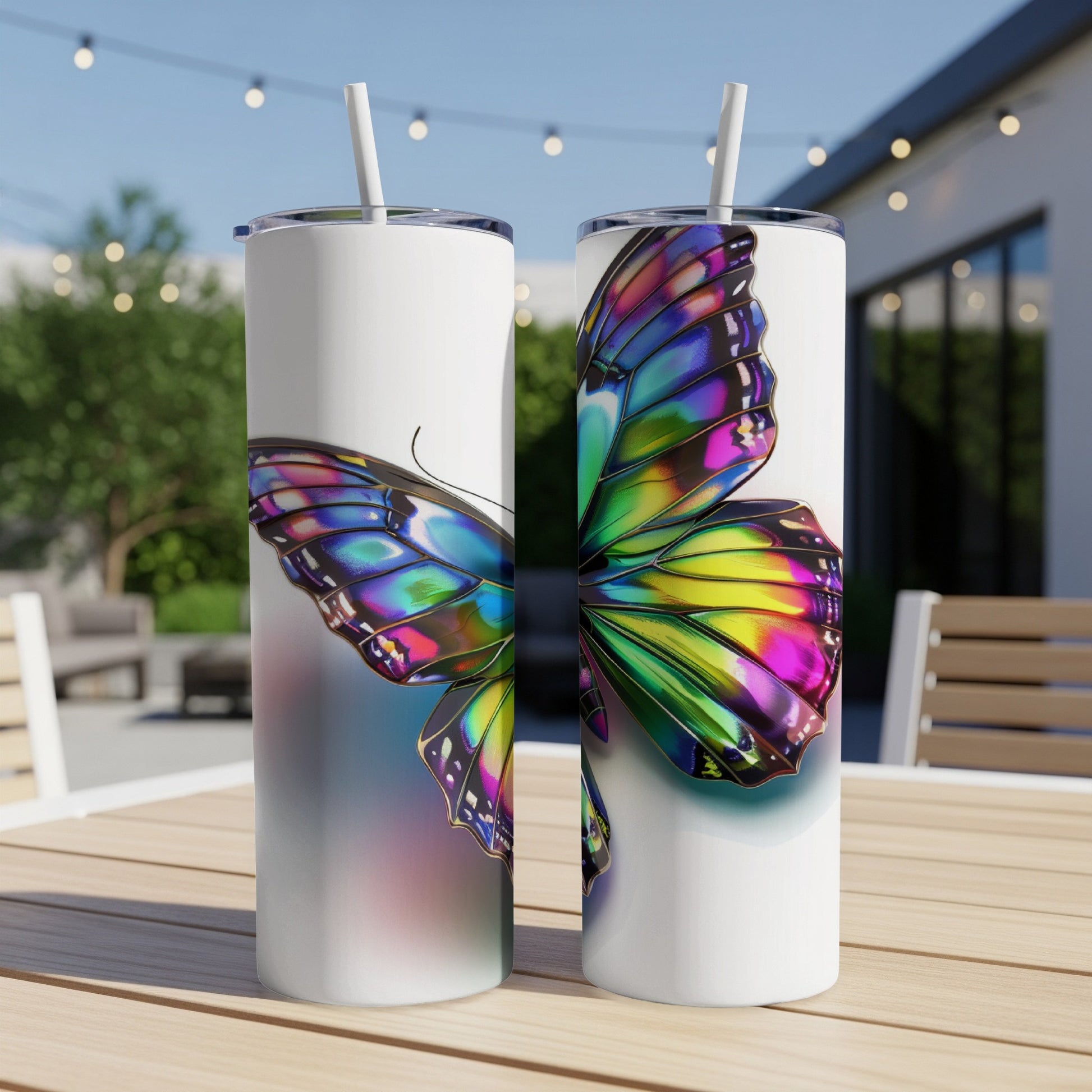 Two white tumblers with iridescent butterfly wing design on a wooden table.