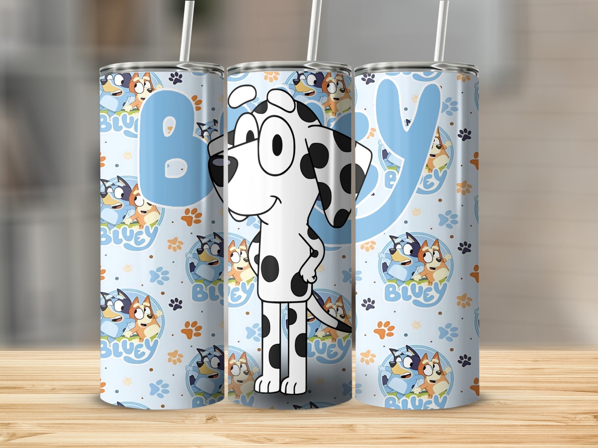 Bluey cartoon characters on a light blue tumbler with white straws.