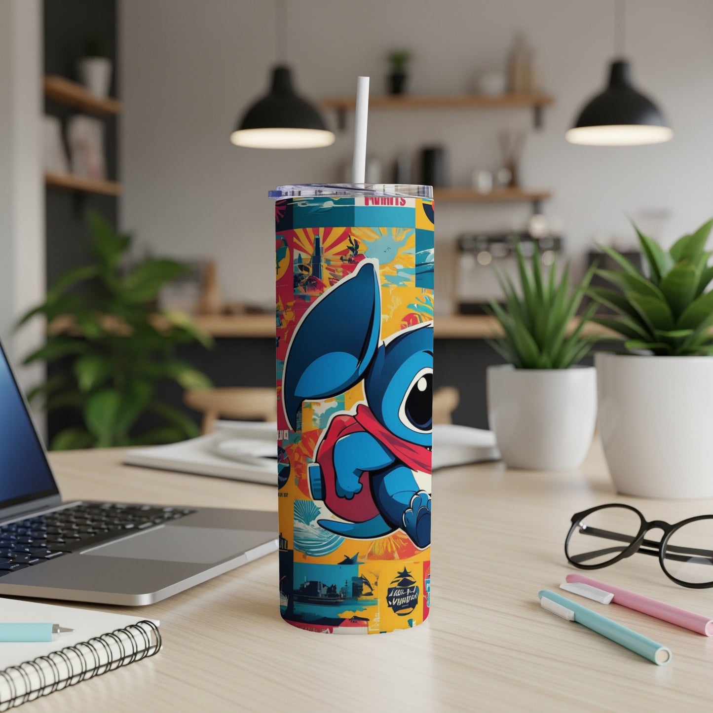 Cartoon Stitch character on a colorful patterned tumbler with straw on a desk.