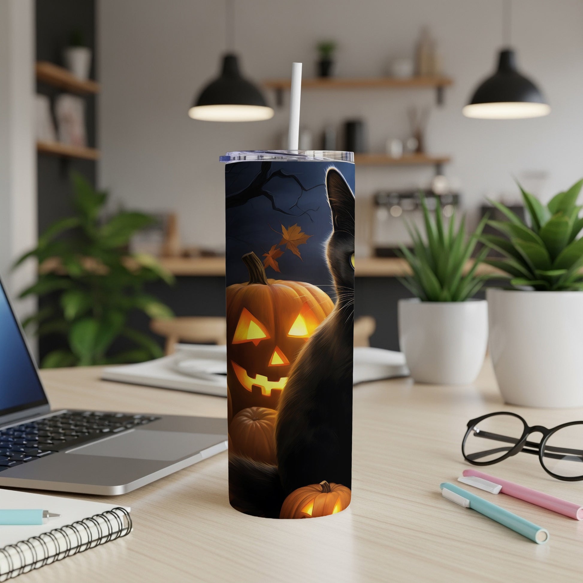 Black cat and jack-o'-lanterns Halloween design on a tumbler with a straw.