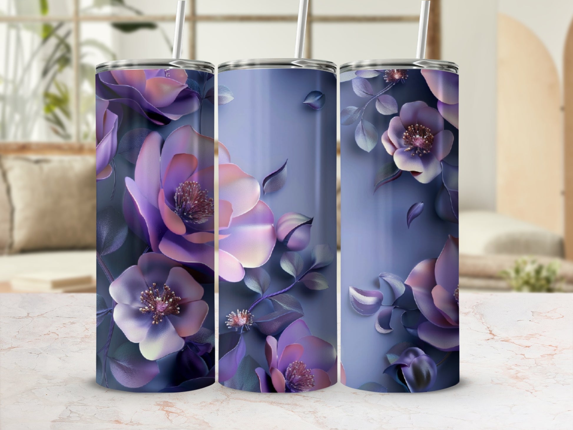 Three tumblers with a purple floral design on a marble surface.