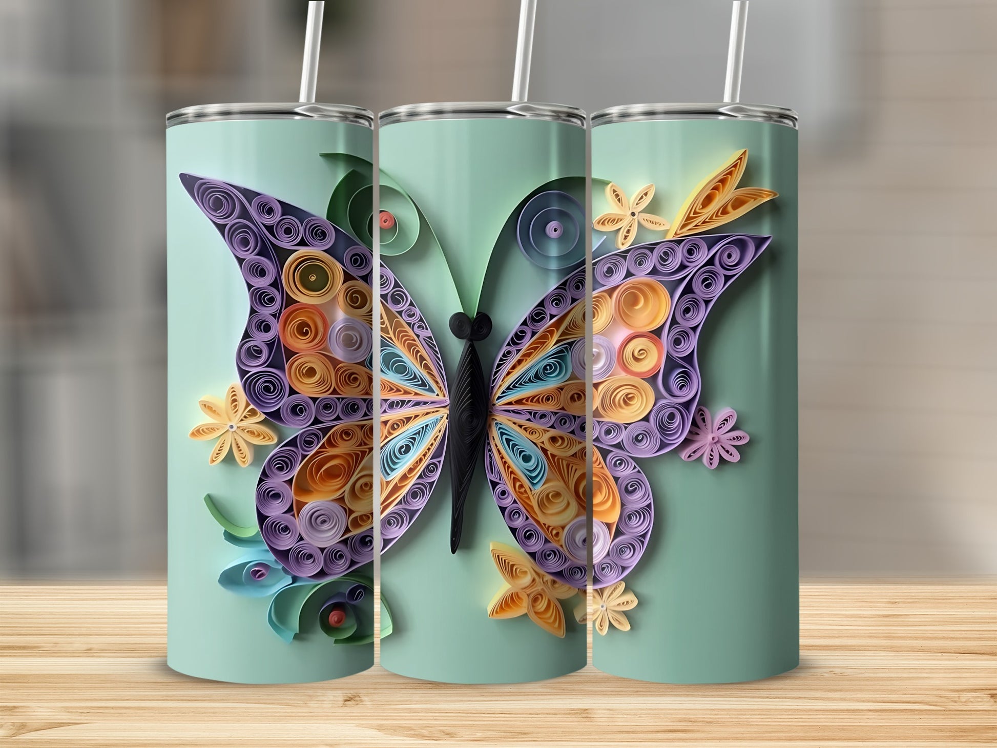 Tumblers with pale green background and quilled butterfly and flower designs.