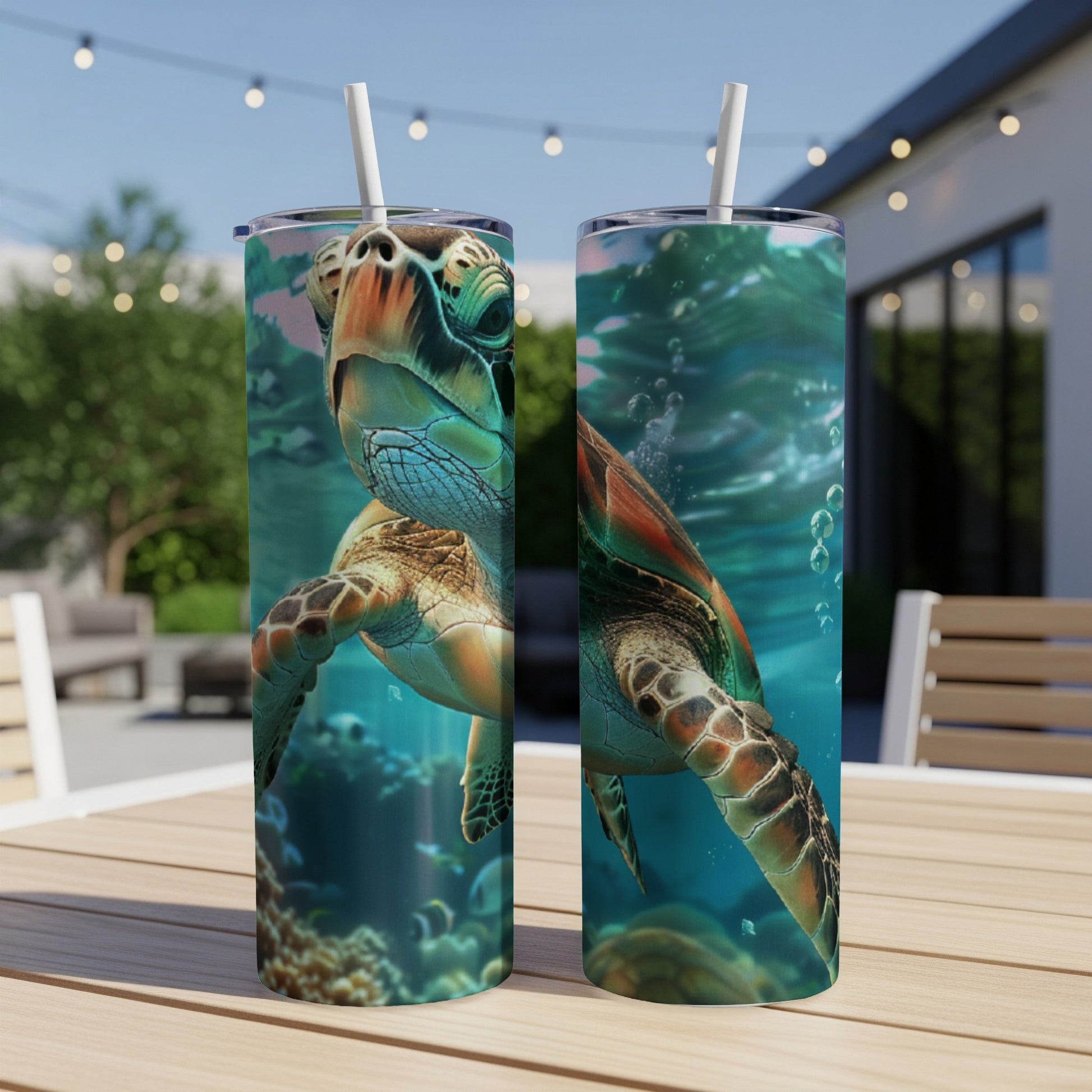 Two tumblers with sea turtle underwater graphics on a table.