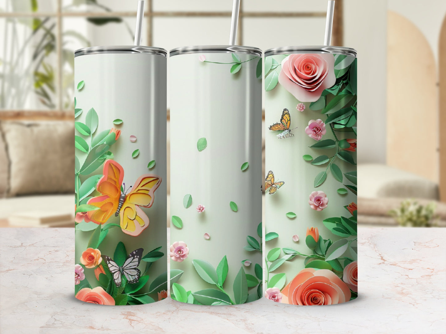 Three tall, skinny tumblers with a floral and butterfly design.