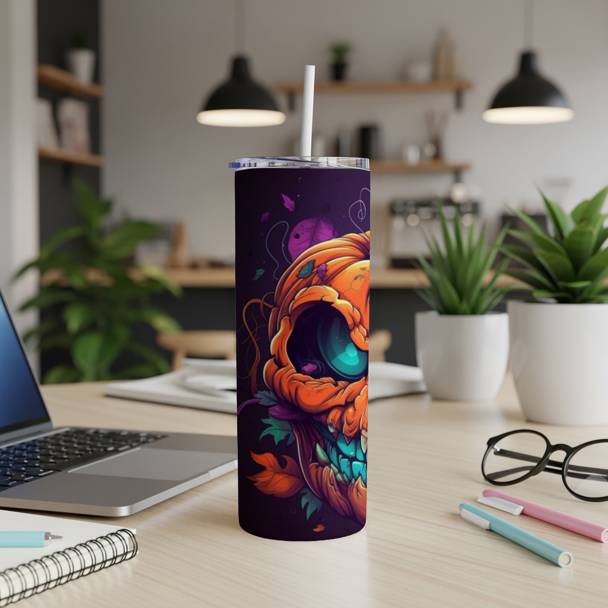 Tall tumbler with a dark purple background and a stylized orange pumpkin skull design.