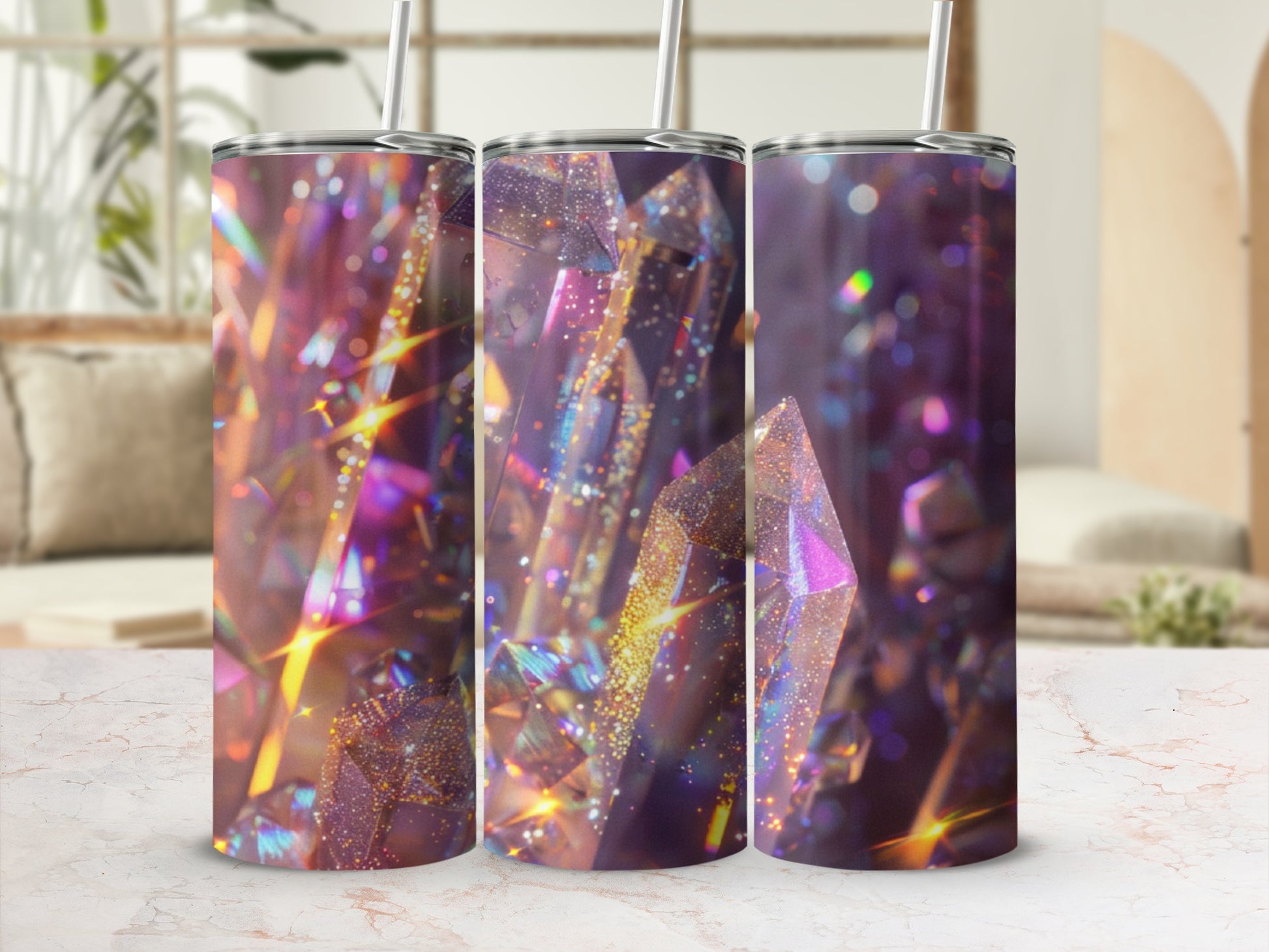 Three tumblers with shimmering, iridescent crystal designs and straws.