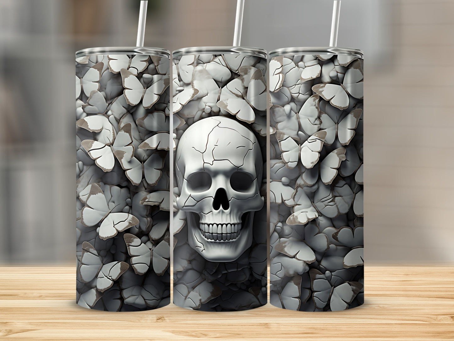 Triptych of tumblers featuring a skull surrounded by butterfly wings.