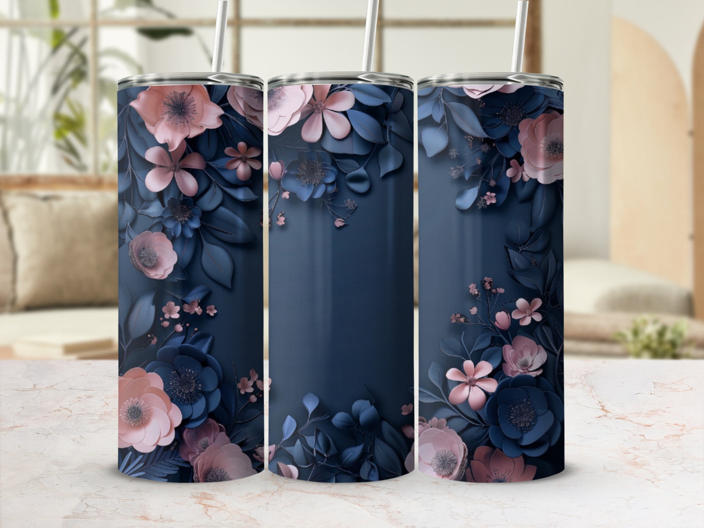Three navy blue tumblers with detailed pink and blue floral designs.