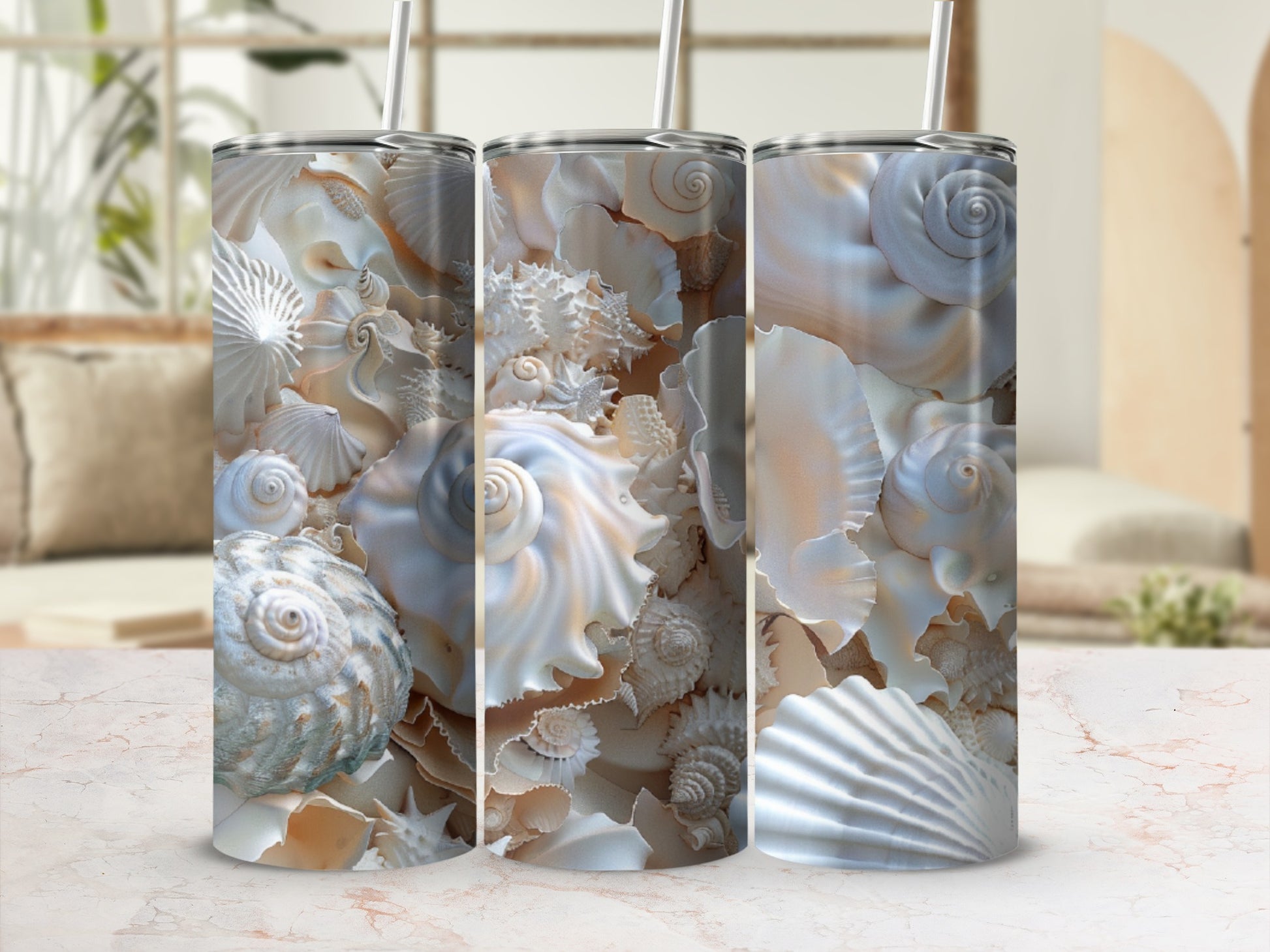 Three tumblers with detailed seashell patterns and straw toppers.