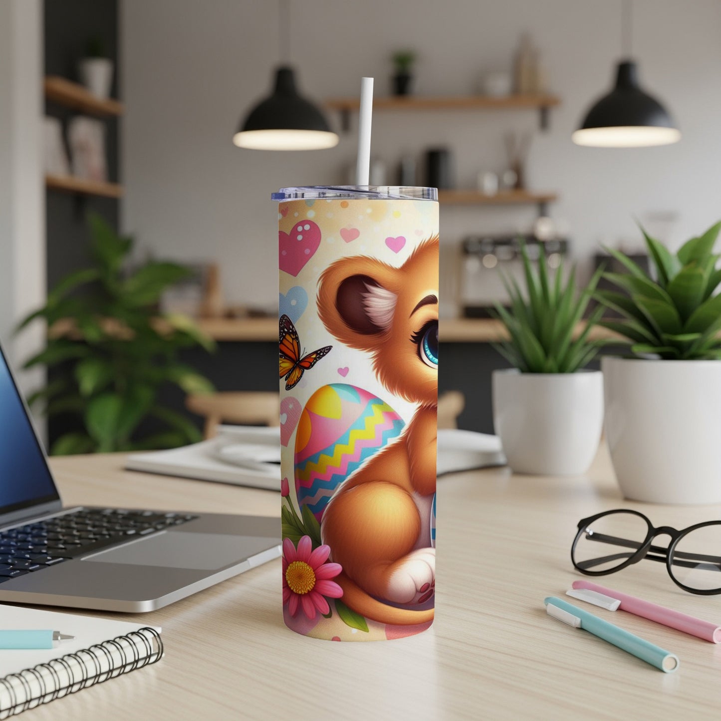Lion cub with Easter egg, butterfly, and flowers on a tumbler.