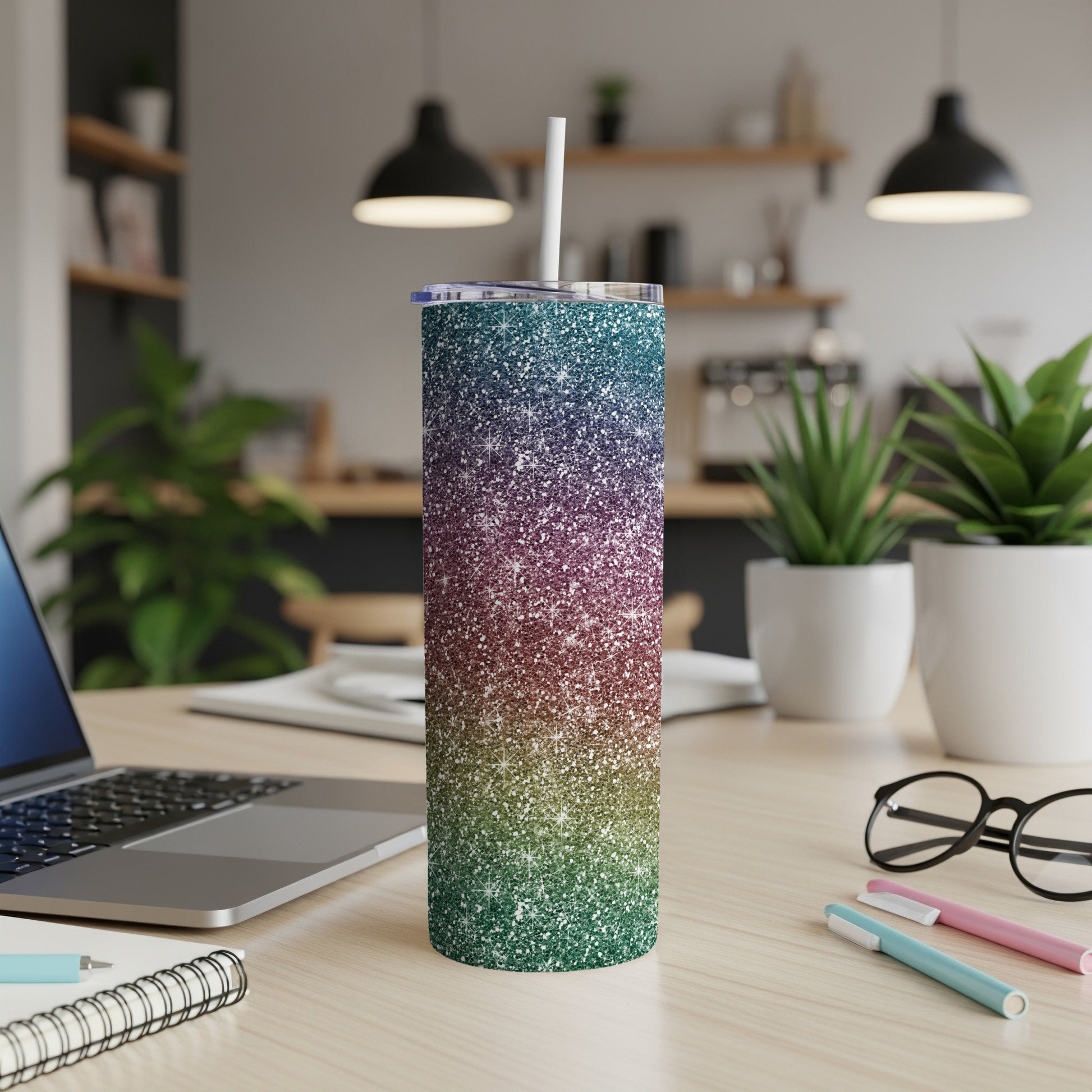 Glitter tumbler with ombre blue, purple, and green colors and a white straw.