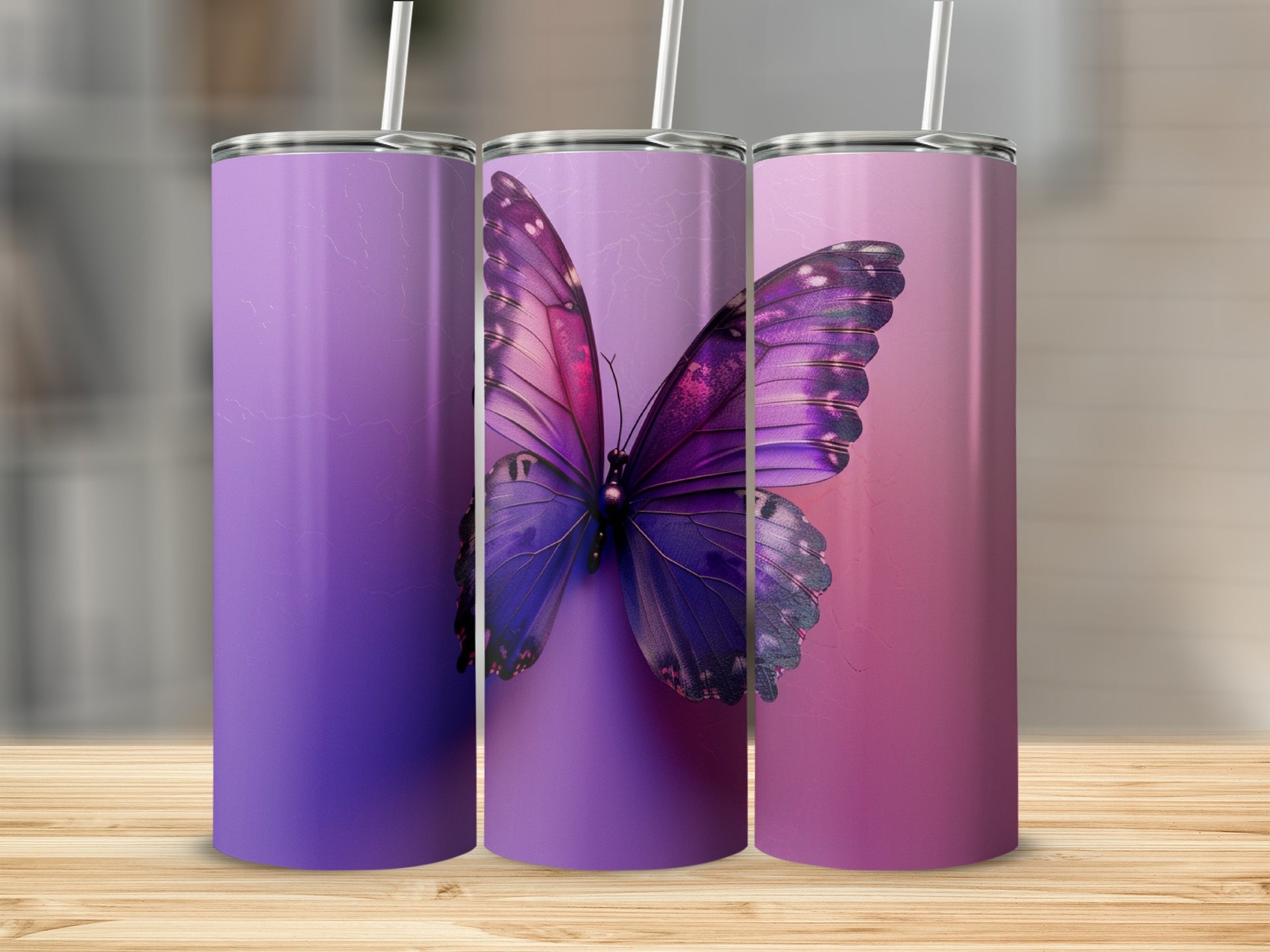 Three tumblers with a purple butterfly design against a gradient background.